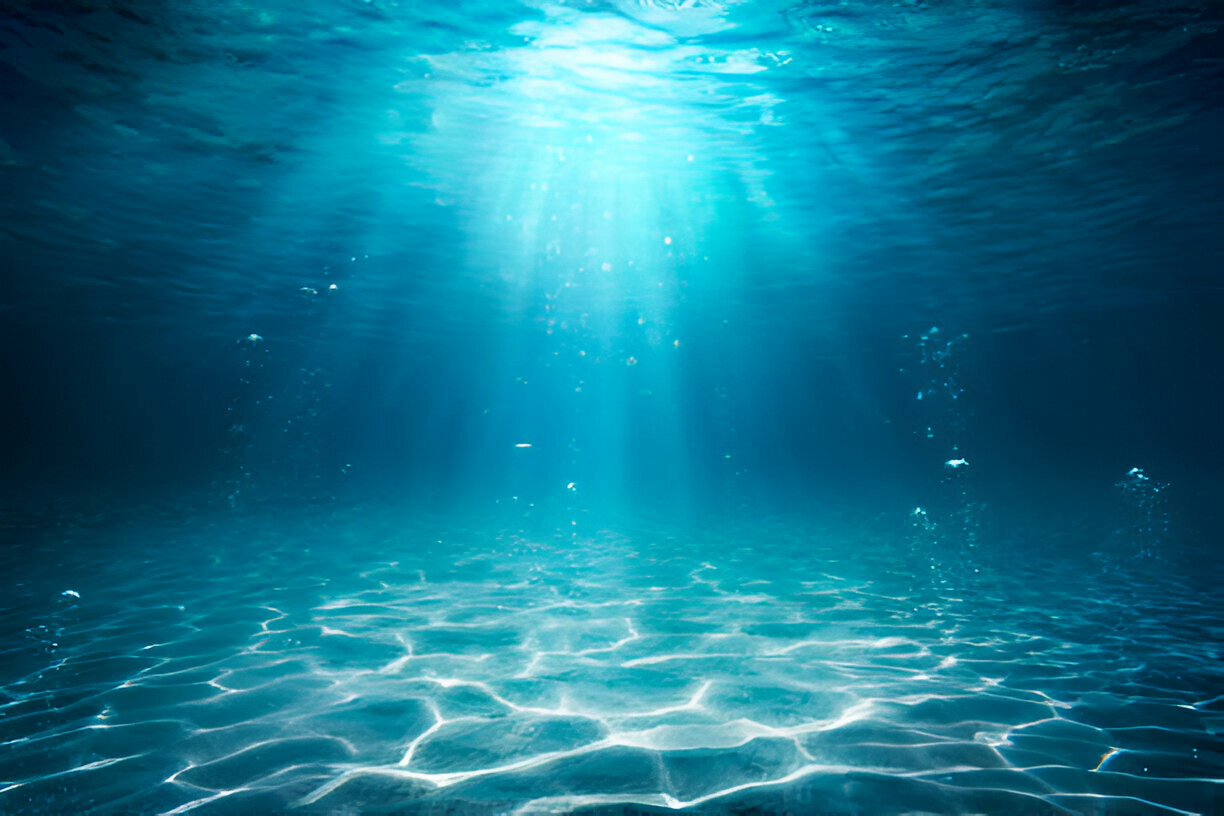 Underwater scene with sunlight streaming through clear blue water