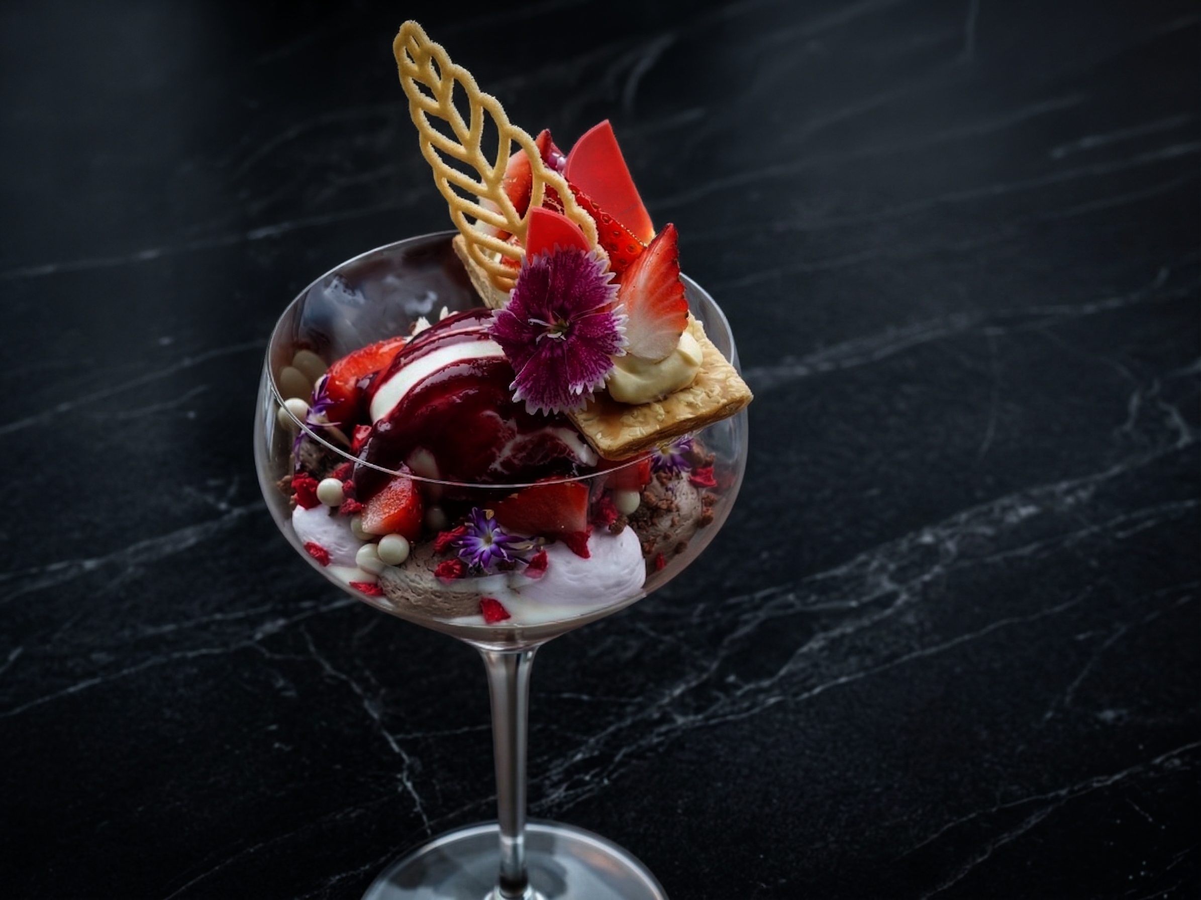 Luxury strawberry parfait with golden leaf and floral decoration