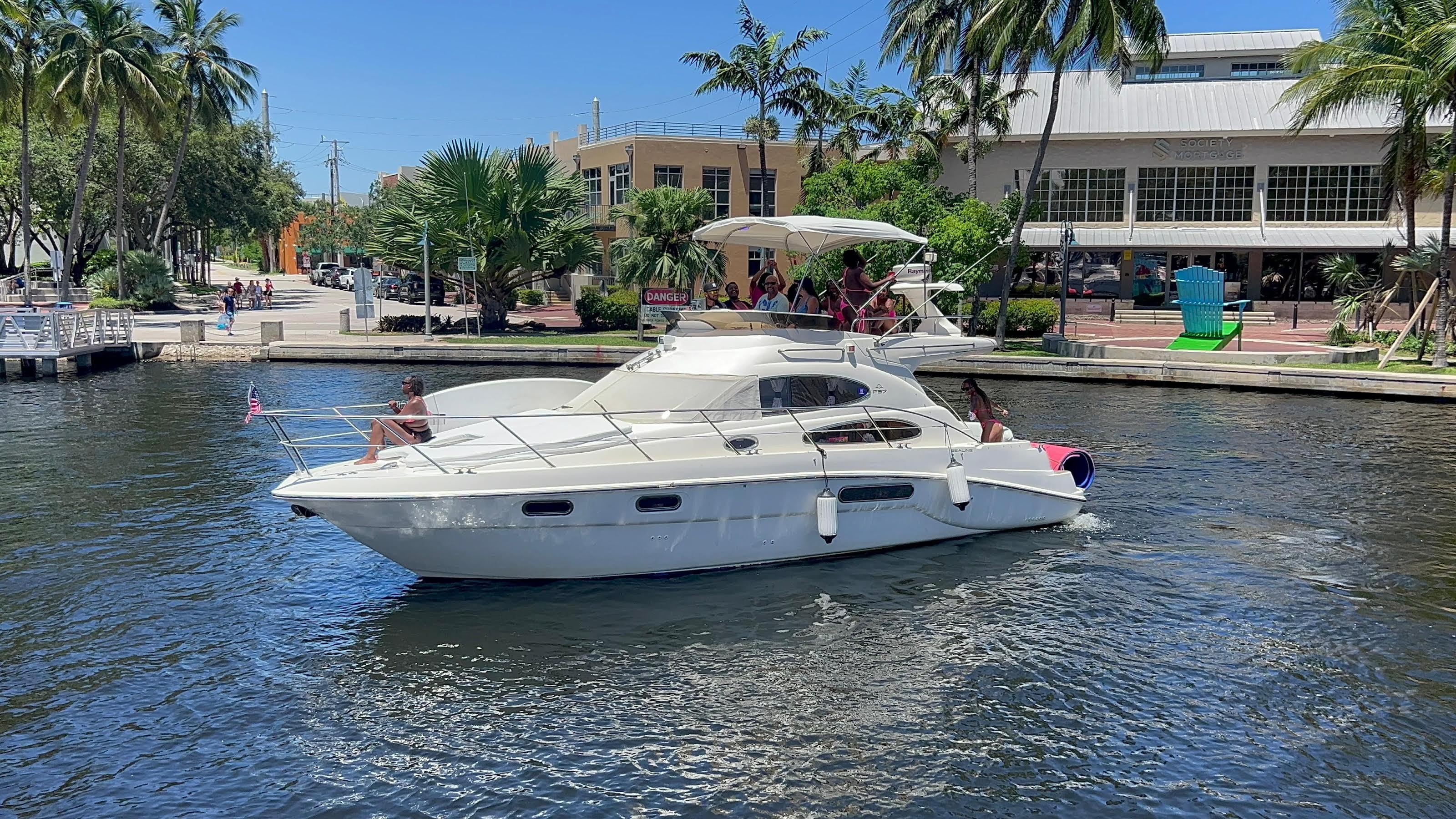 Sealine F37 cruising canal with guests aboard
