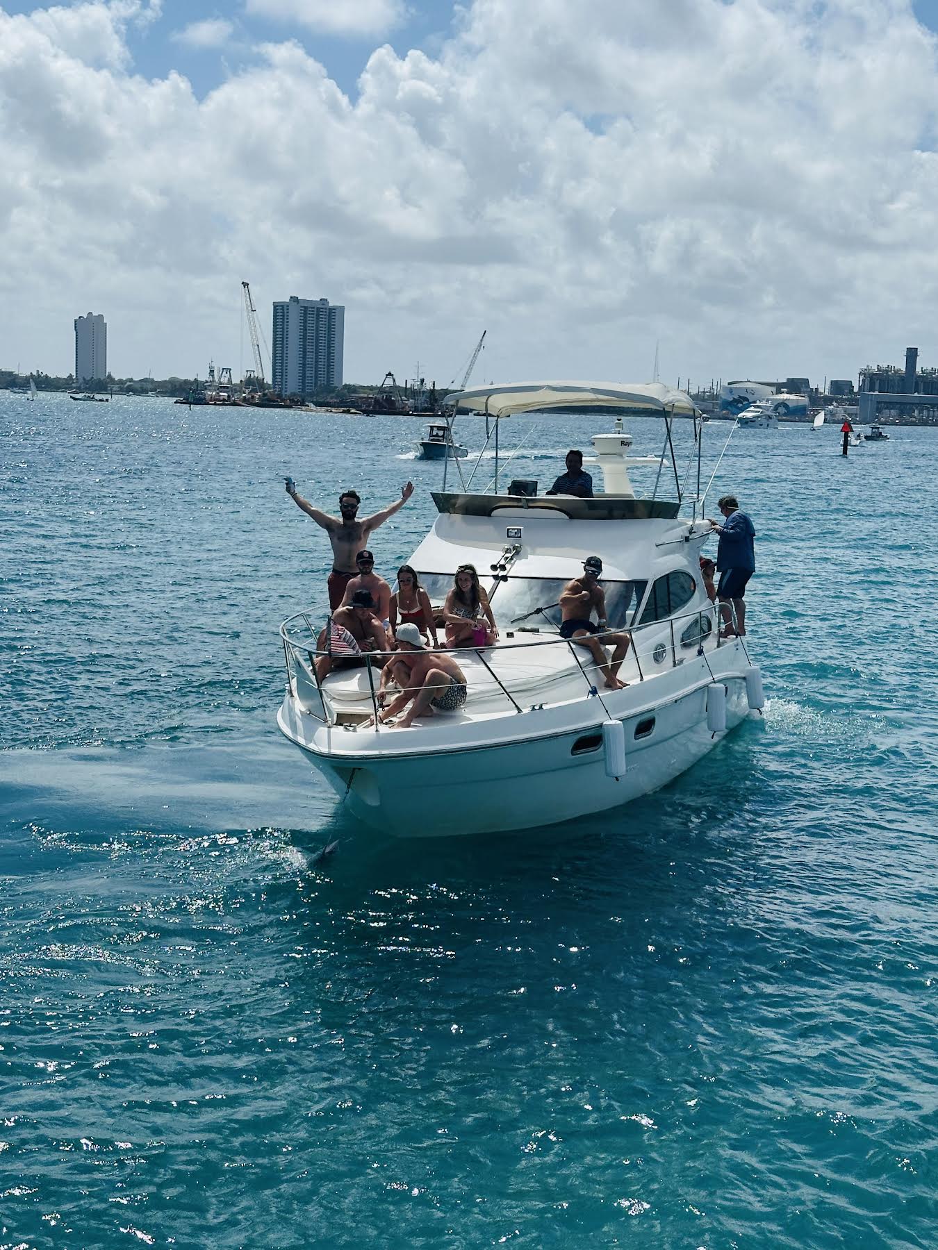 Guests celebrating on Sealine F37 bow in turquoise water