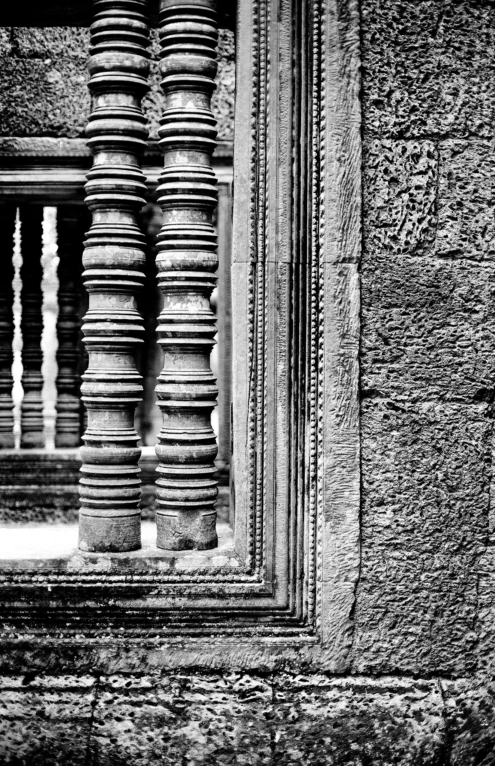 Decorative stone column bases with elaborate carved Buddhist designs and motifs