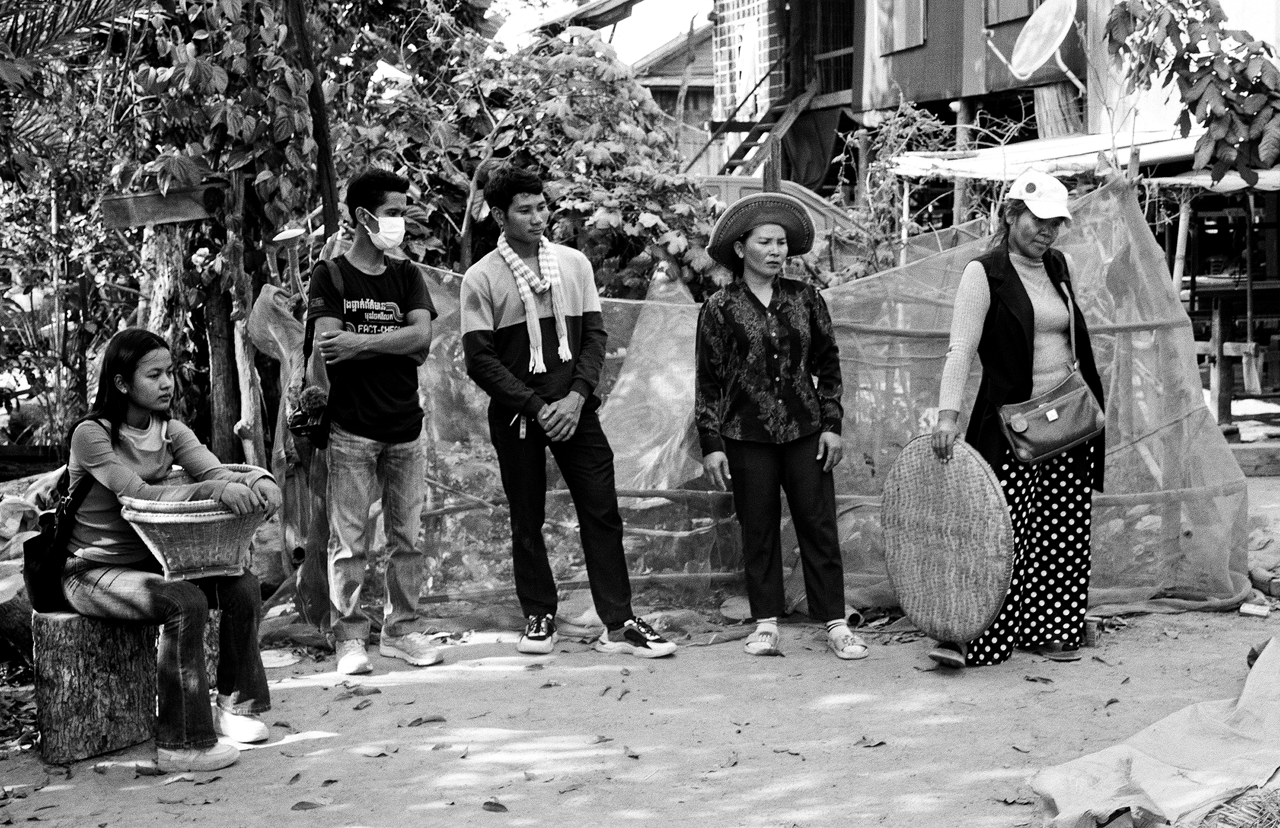 Group of Cambodian villagers standing together in rural community setting