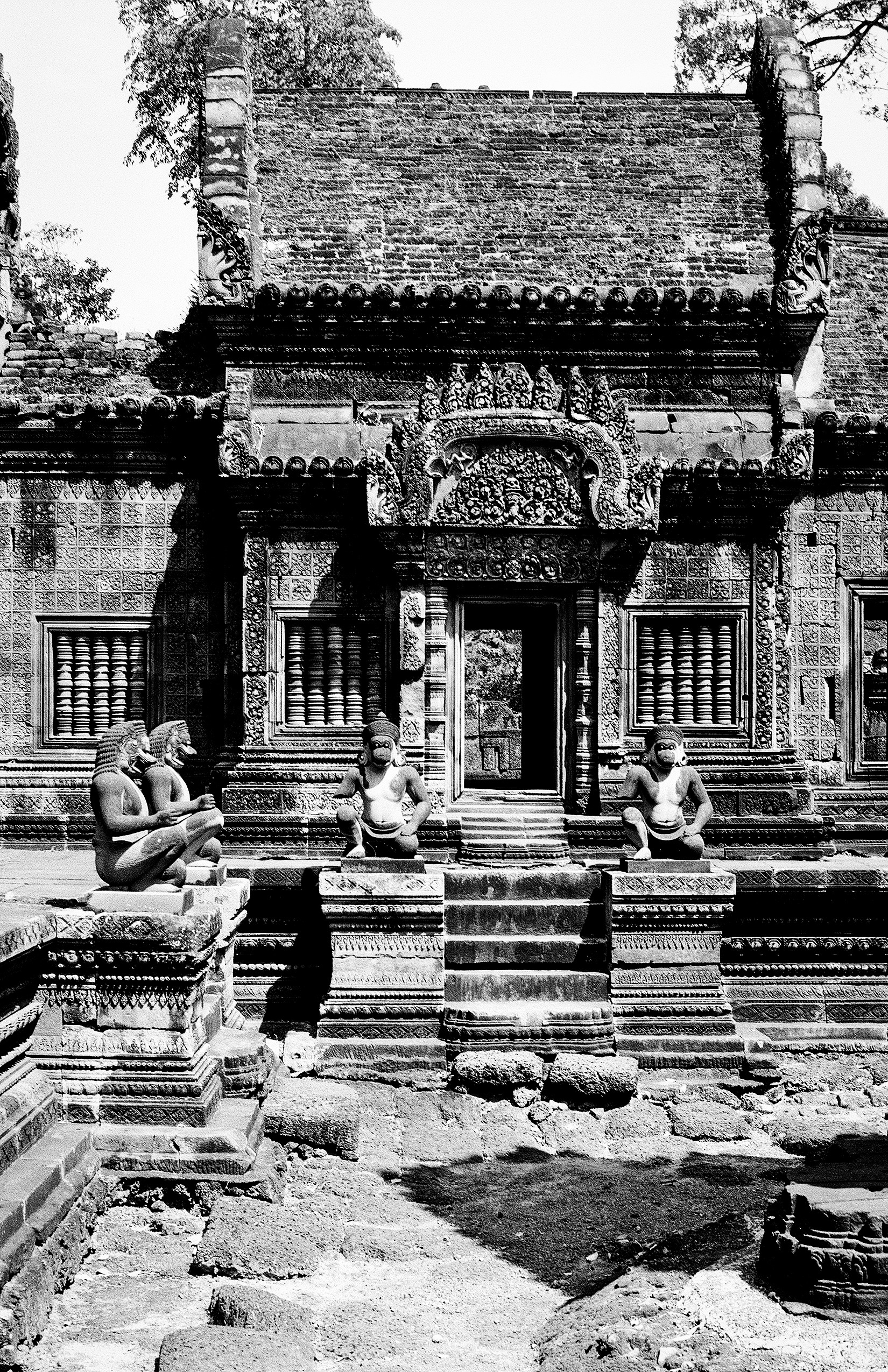 Ornate temple shrine with multiple tiers of carved stone guardian figures