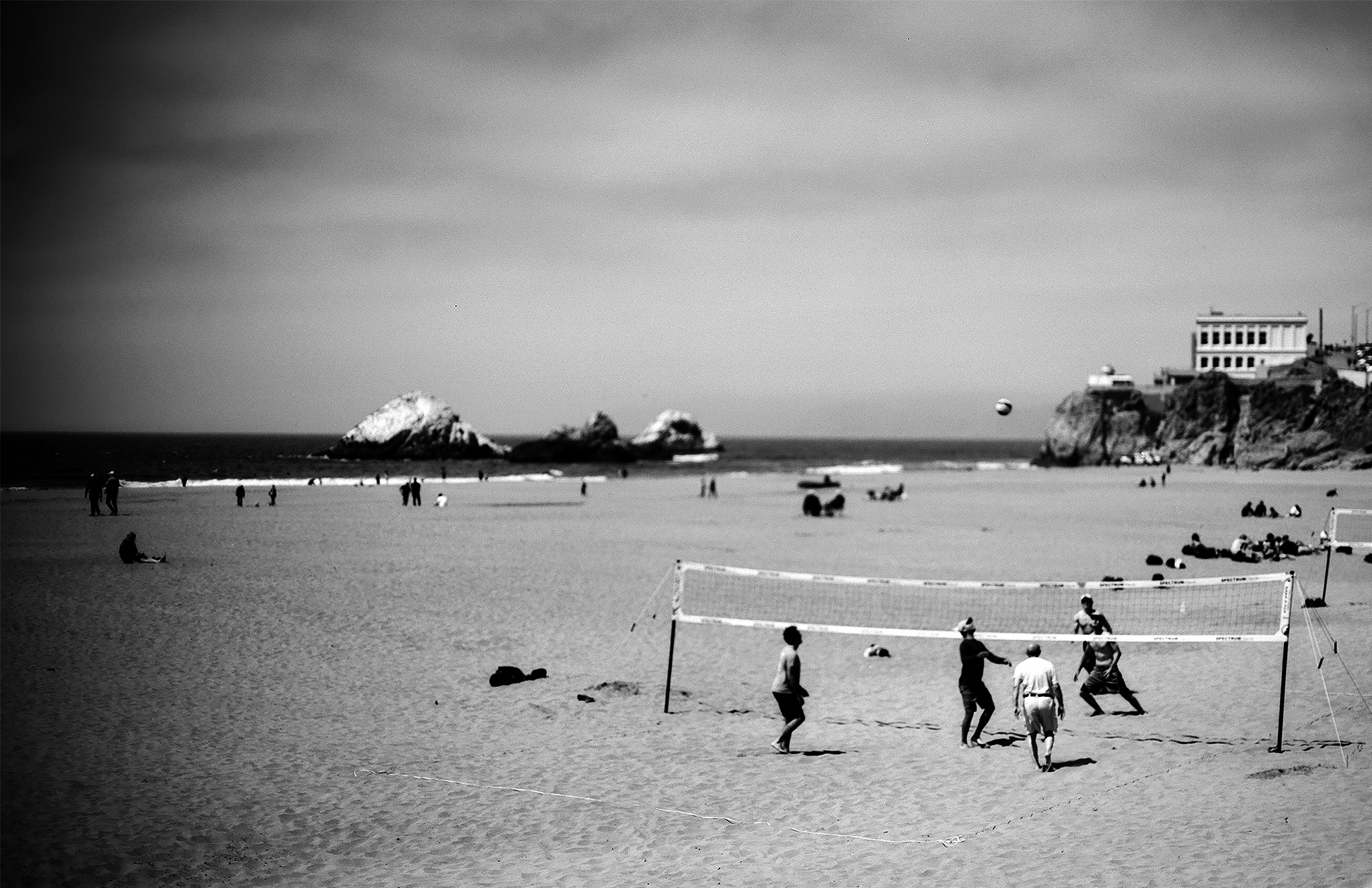 Ocean Beach volleyball game with Cliff House and Seal Rocks visible in background