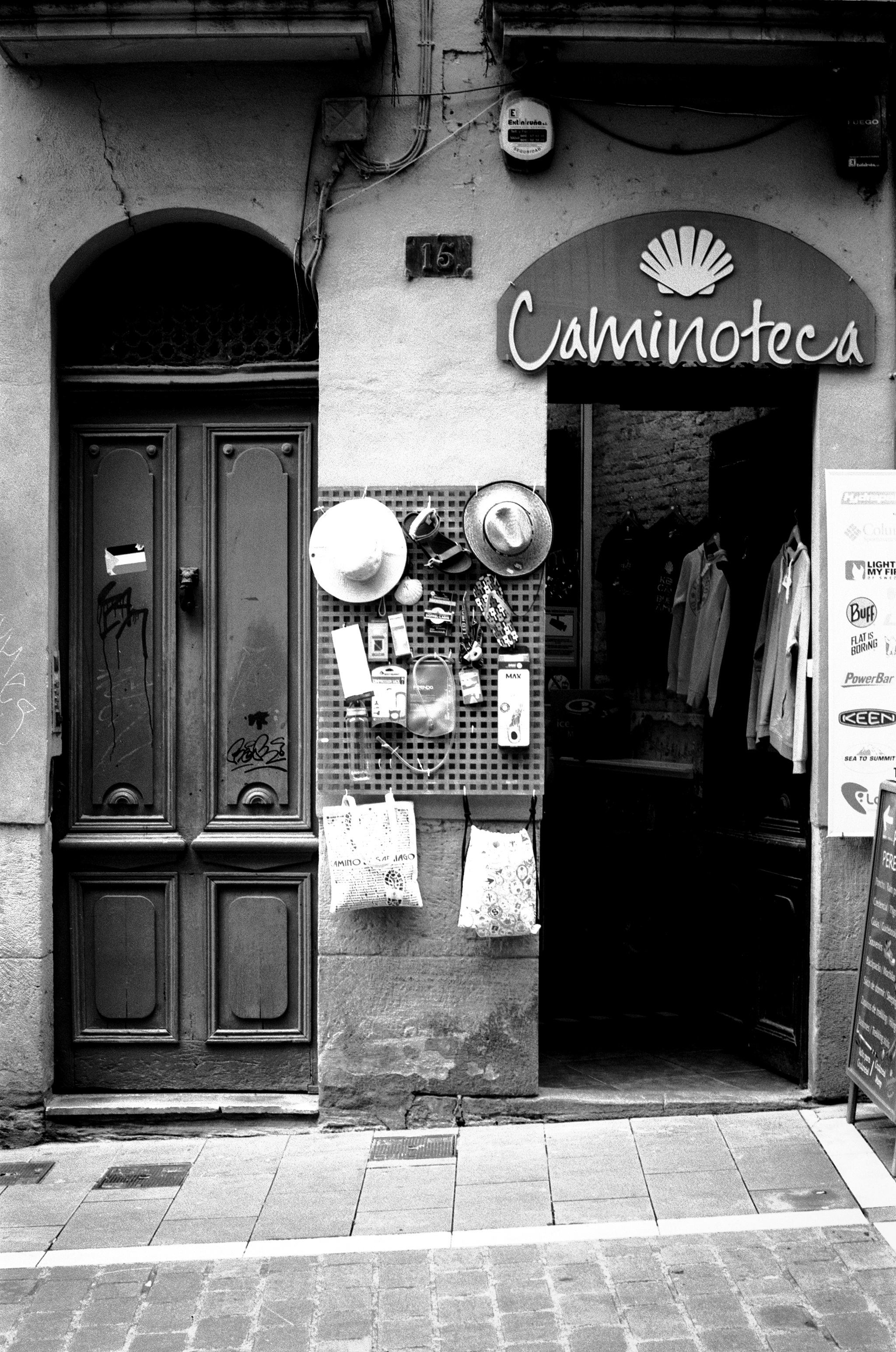 Shop storefront with Caminoteca sign and hats displayed with merchandise