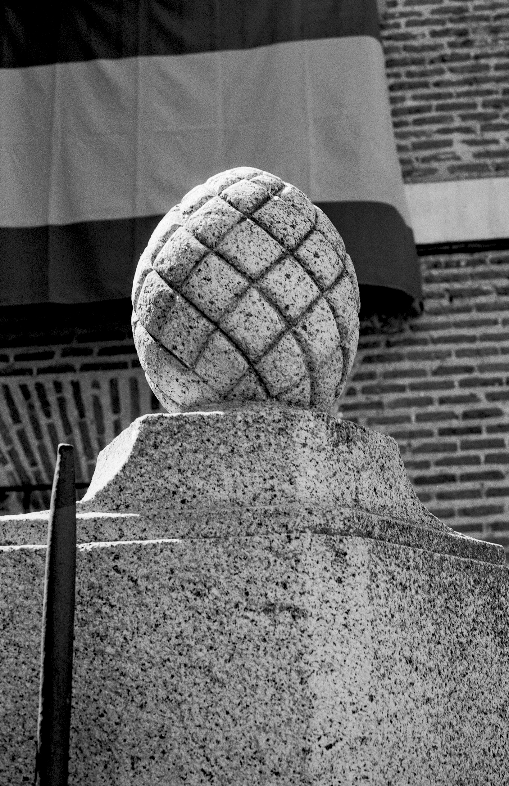 Abstract stone sculpture with geometric quilted or latticed surface pattern