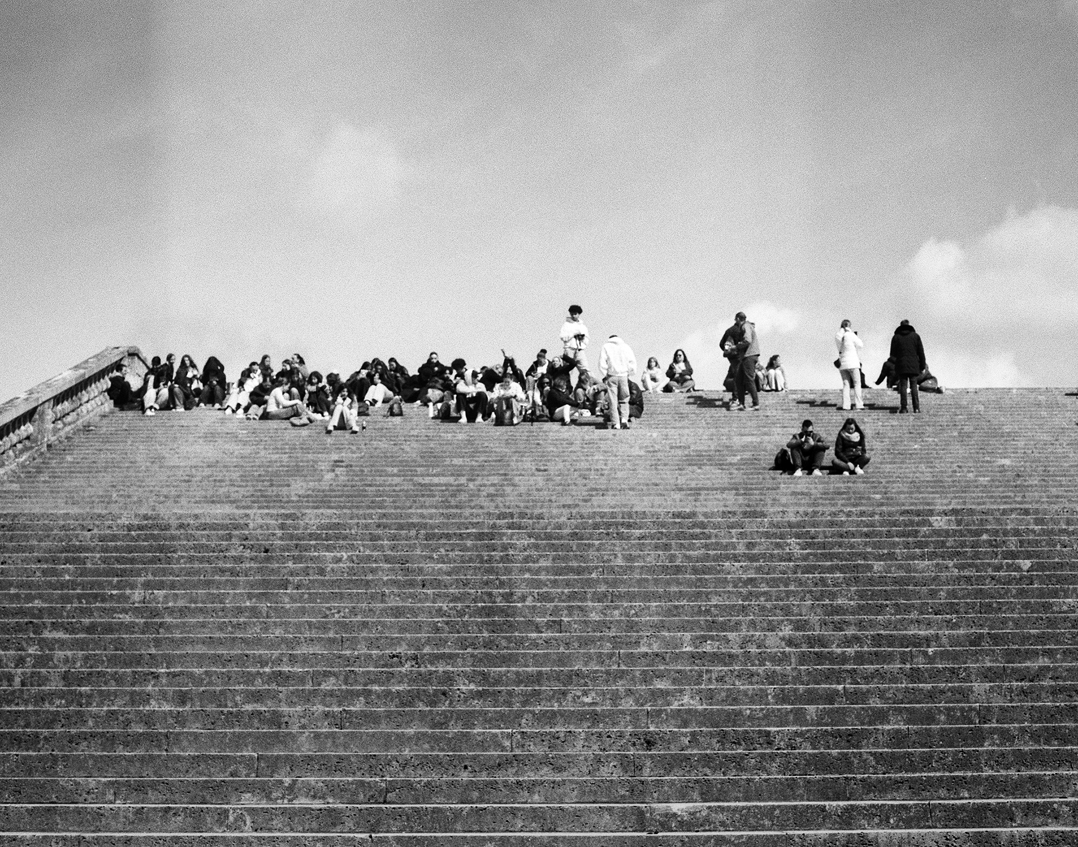 Sacré-Cœur basilica steps with crowds of people resting and sitting