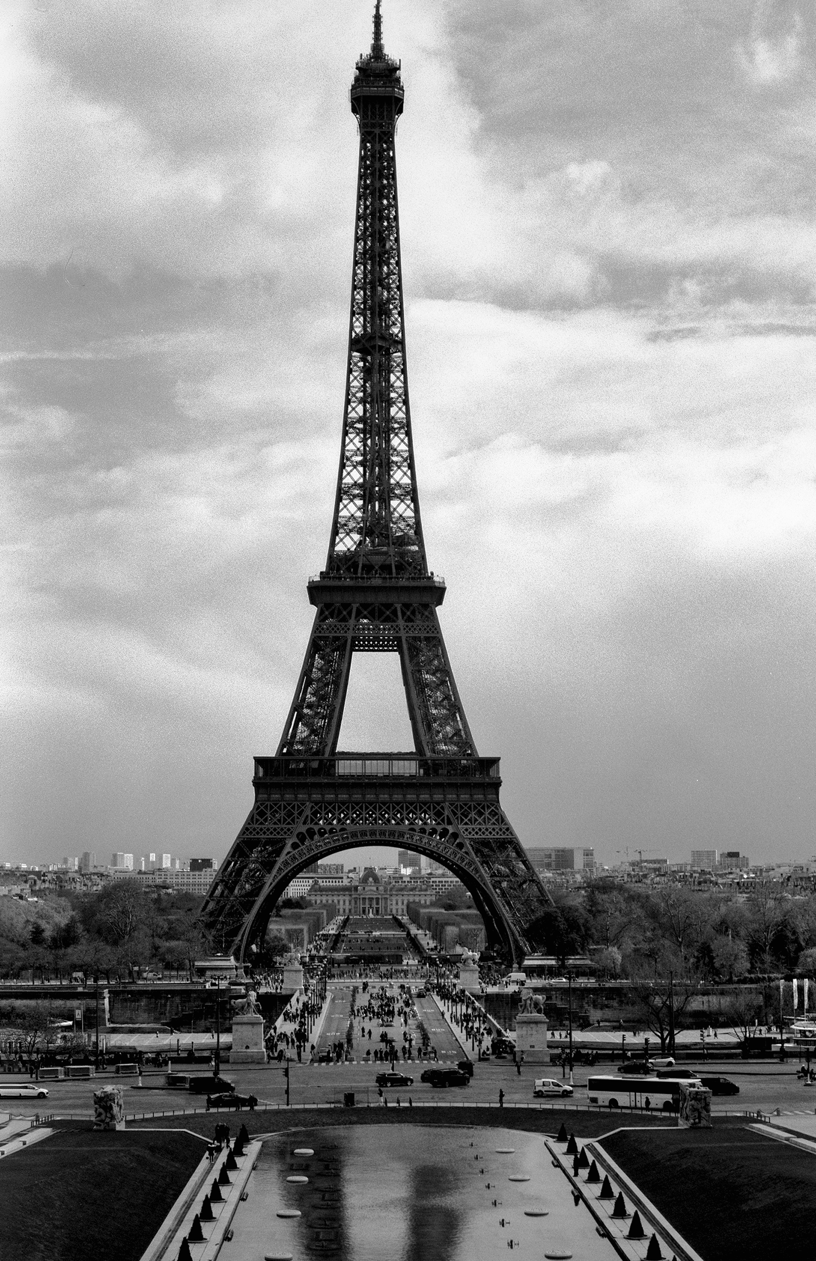 Eiffel Tower viewed from Trocadéro with crowds at fountain and dramatic sky