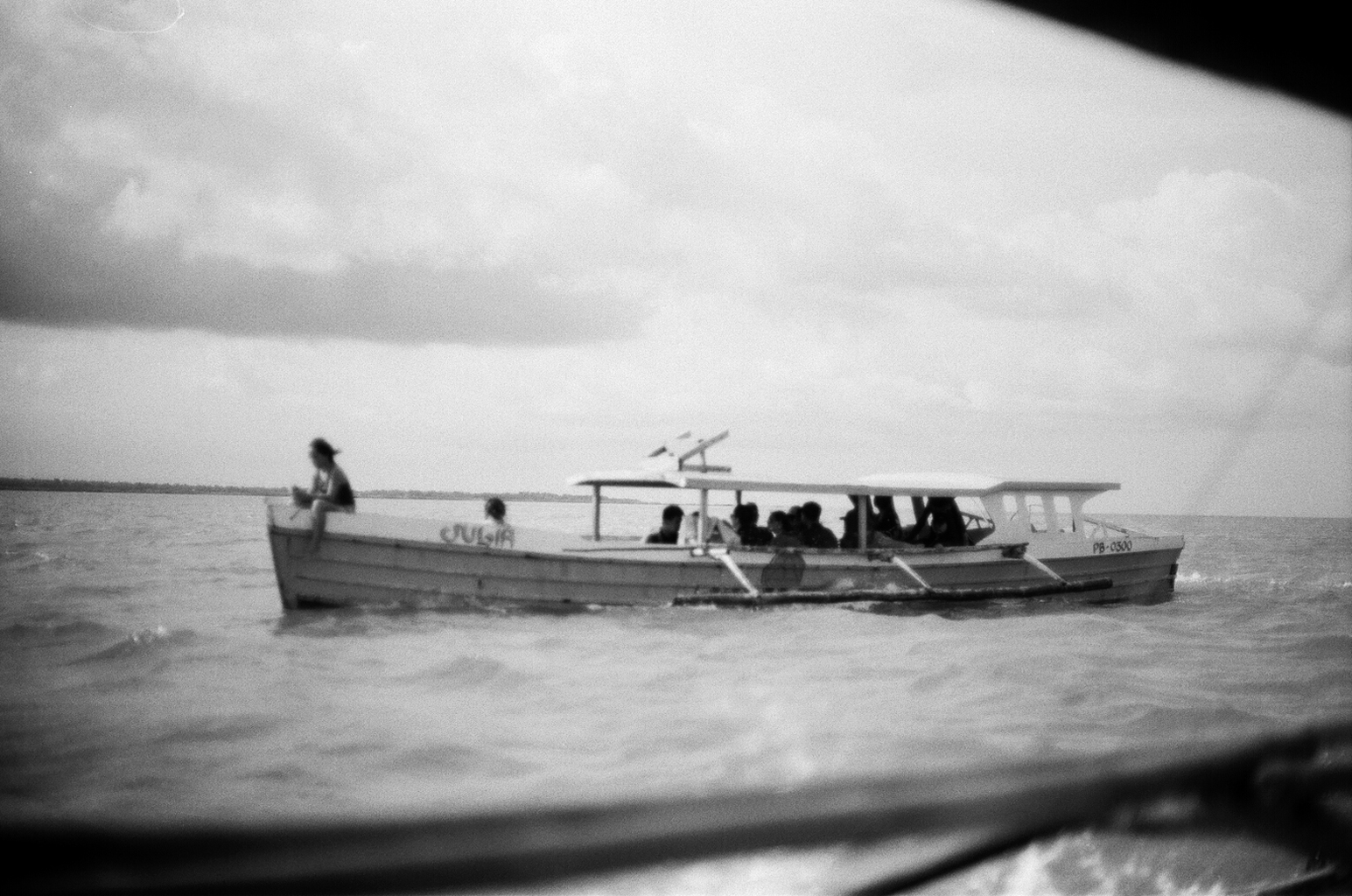 Traditional Filipino pump boat named Julia with passengers crossing the open water