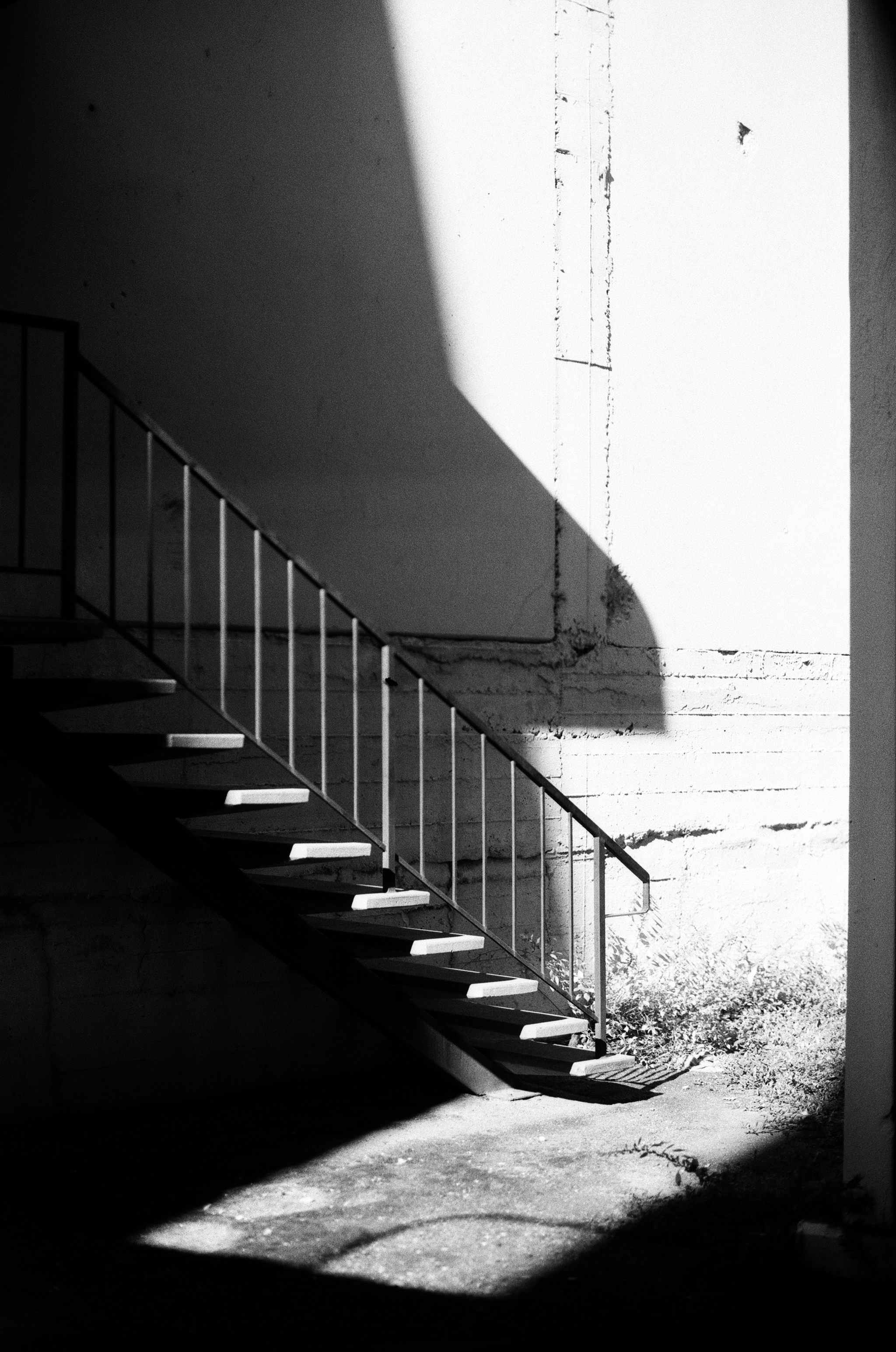 Concrete stairs with strong sunlight creating sharp shadows and geometric patterns