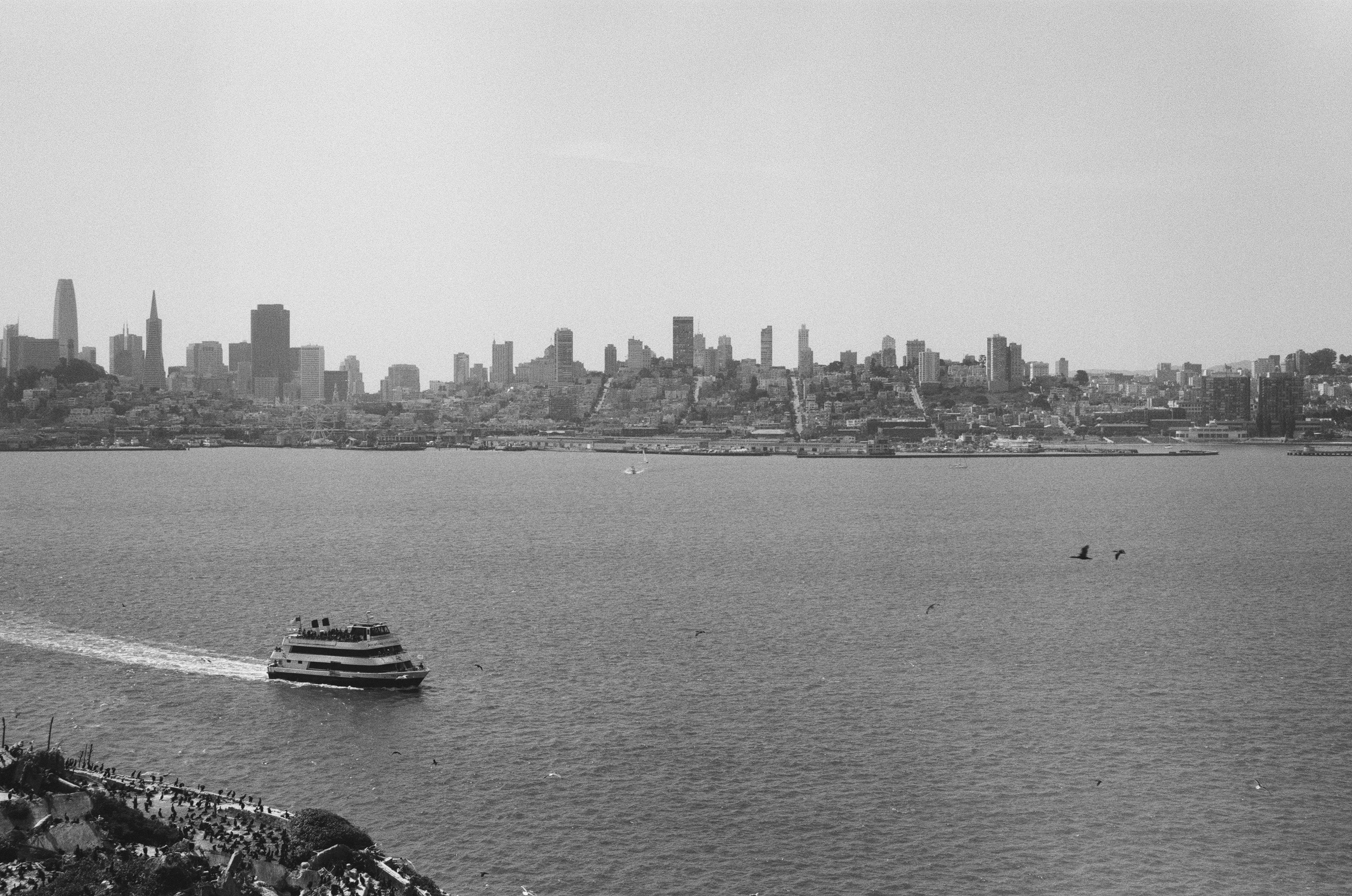 San Francisco skyline across bay with ferry boat approaching waterfront