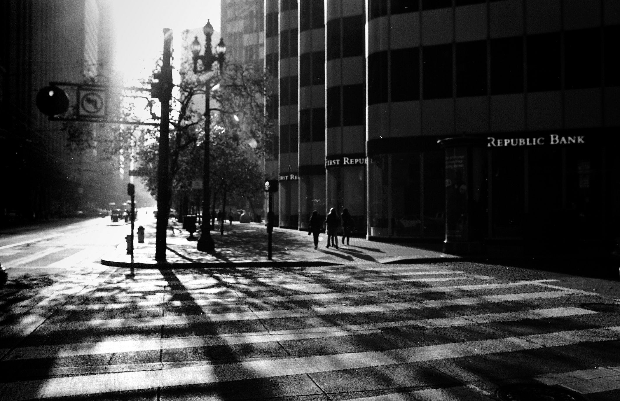Financial district street with Republic Bank building and lamp posts casting long shadows