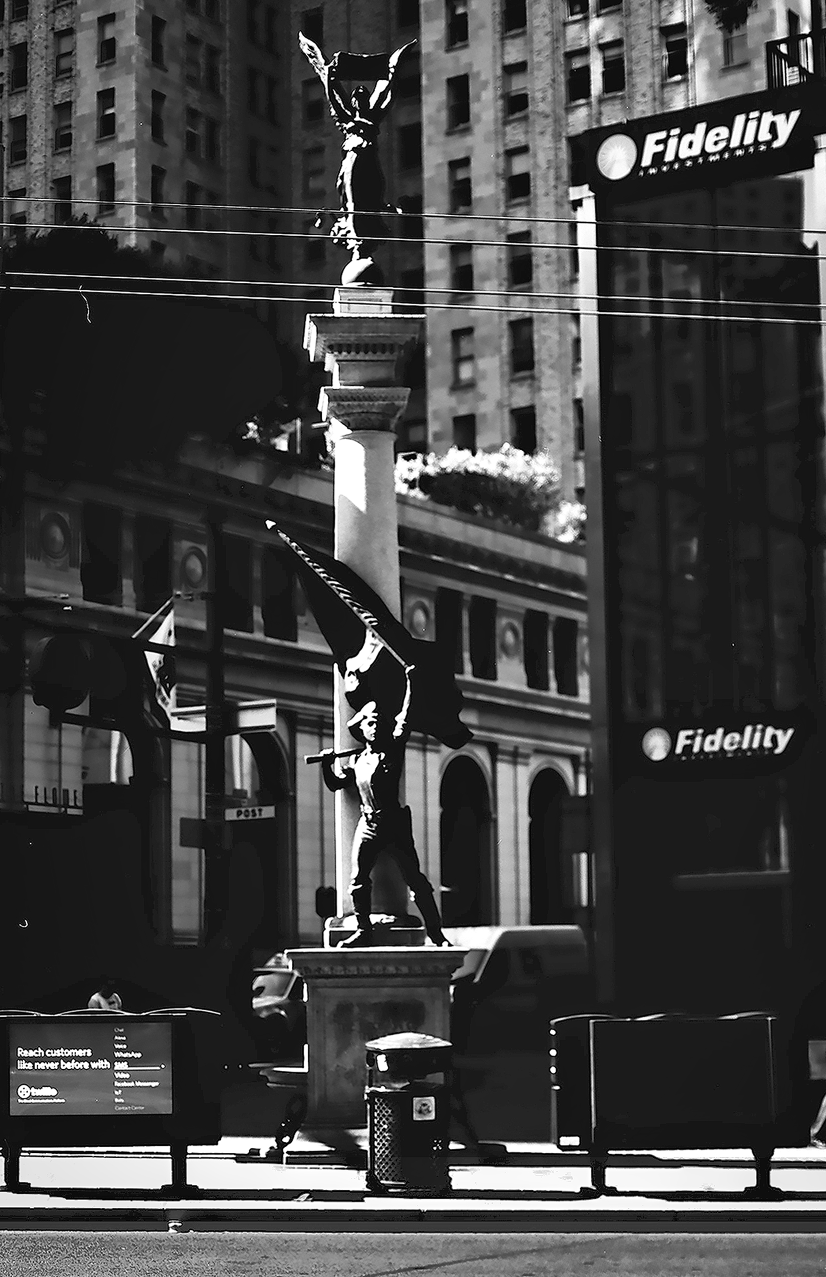 Union Square Dewey Monument Victory statue on column with Fidelity signs and historic downtown buildings in background