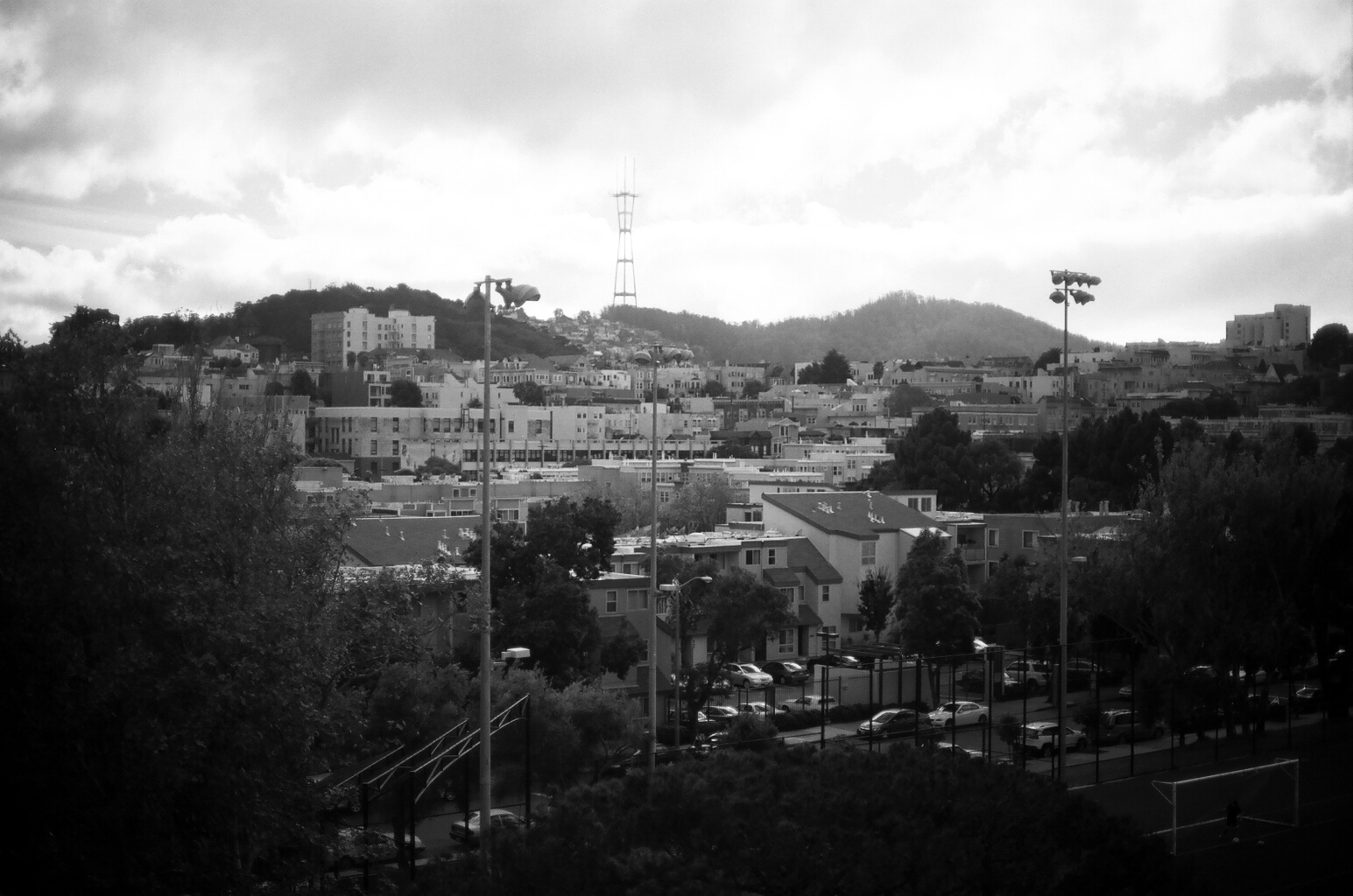 Wide cityscape view from elevated vantage showing Coit Tower on Telegraph Hill and downtown