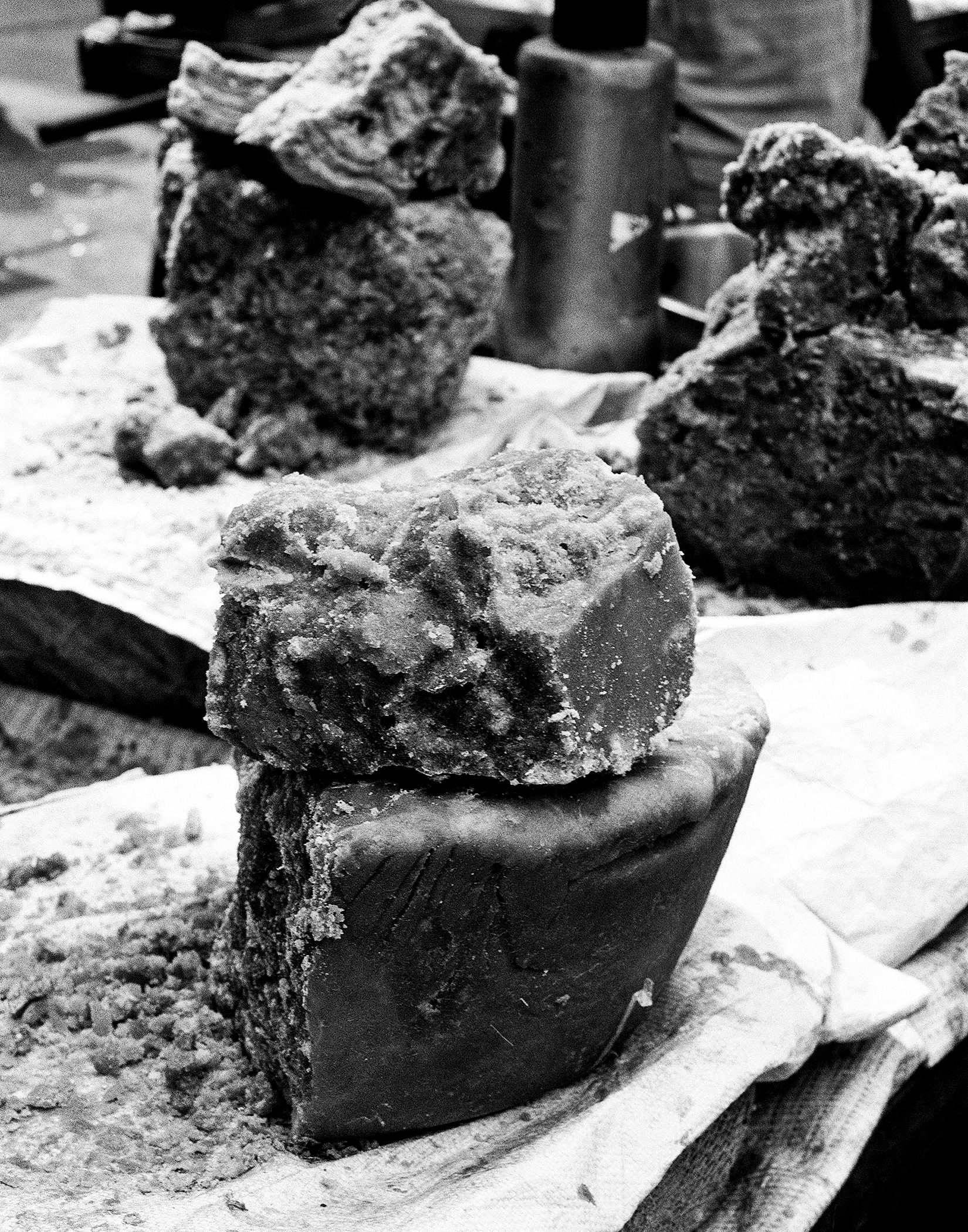 Black and white close-up traditional clay or stone carved decorative objects with textured surfaces