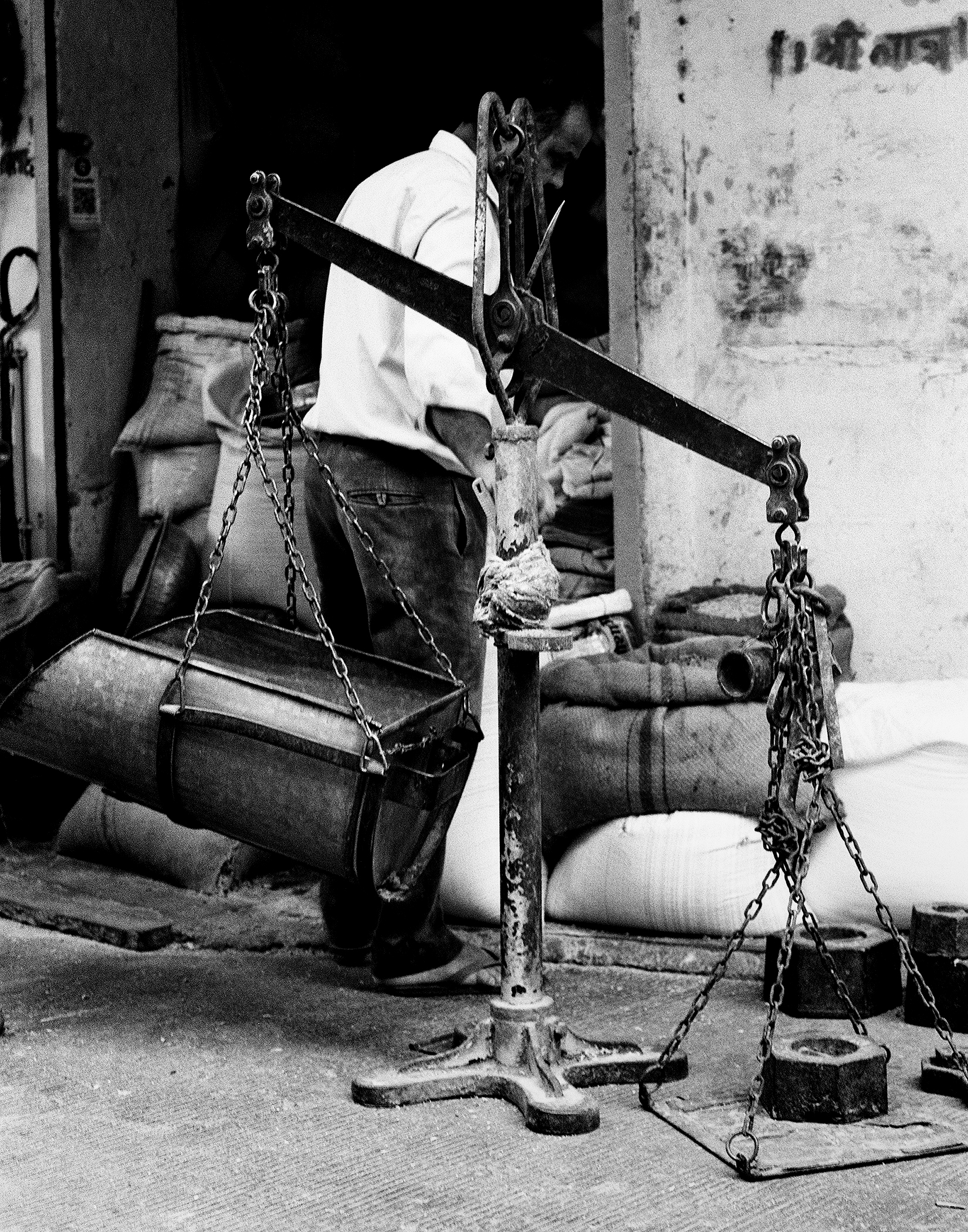 Black and white traditional balance scale for weighing goods with decorative metal work
