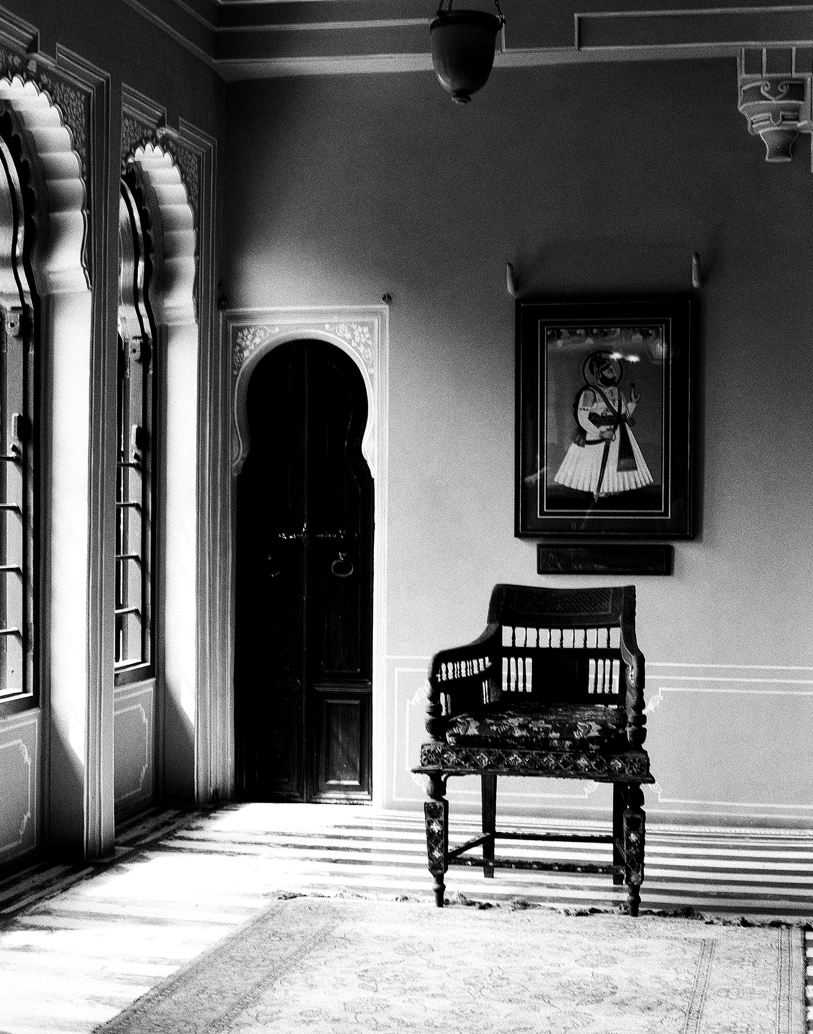 Black and white palace interior room with ornate mirrors doors and decorative architectural elements