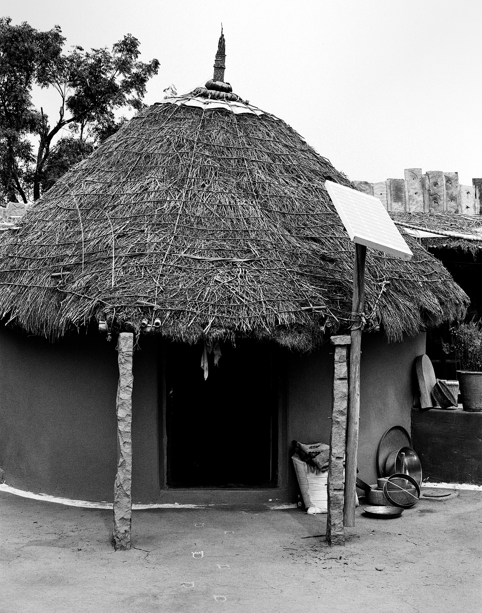 Traditional musician playing ravanhatta against stone wall