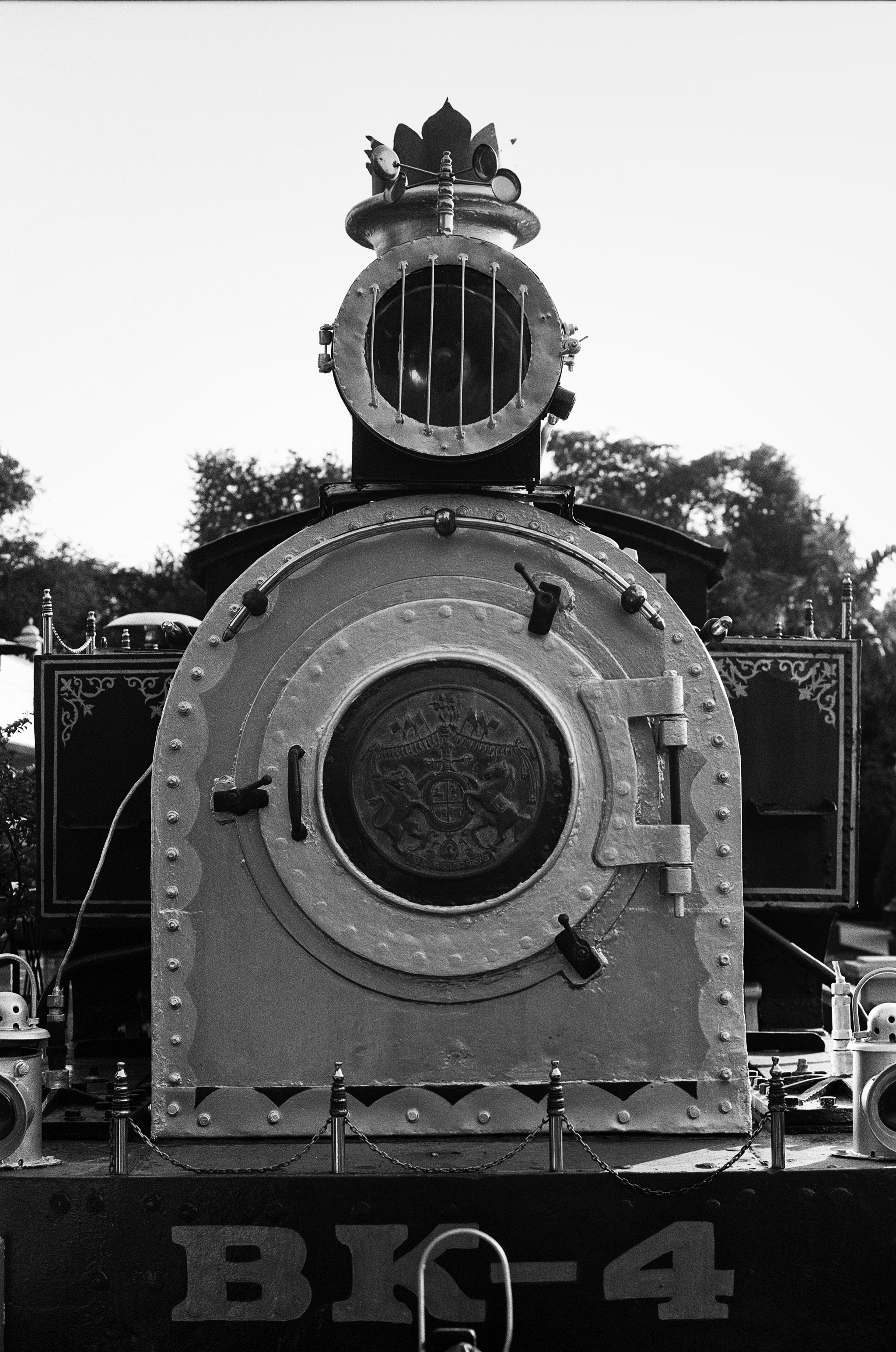 Black and white historic steam locomotive BK-4 with ornamental crown emblem and royal insignia on display