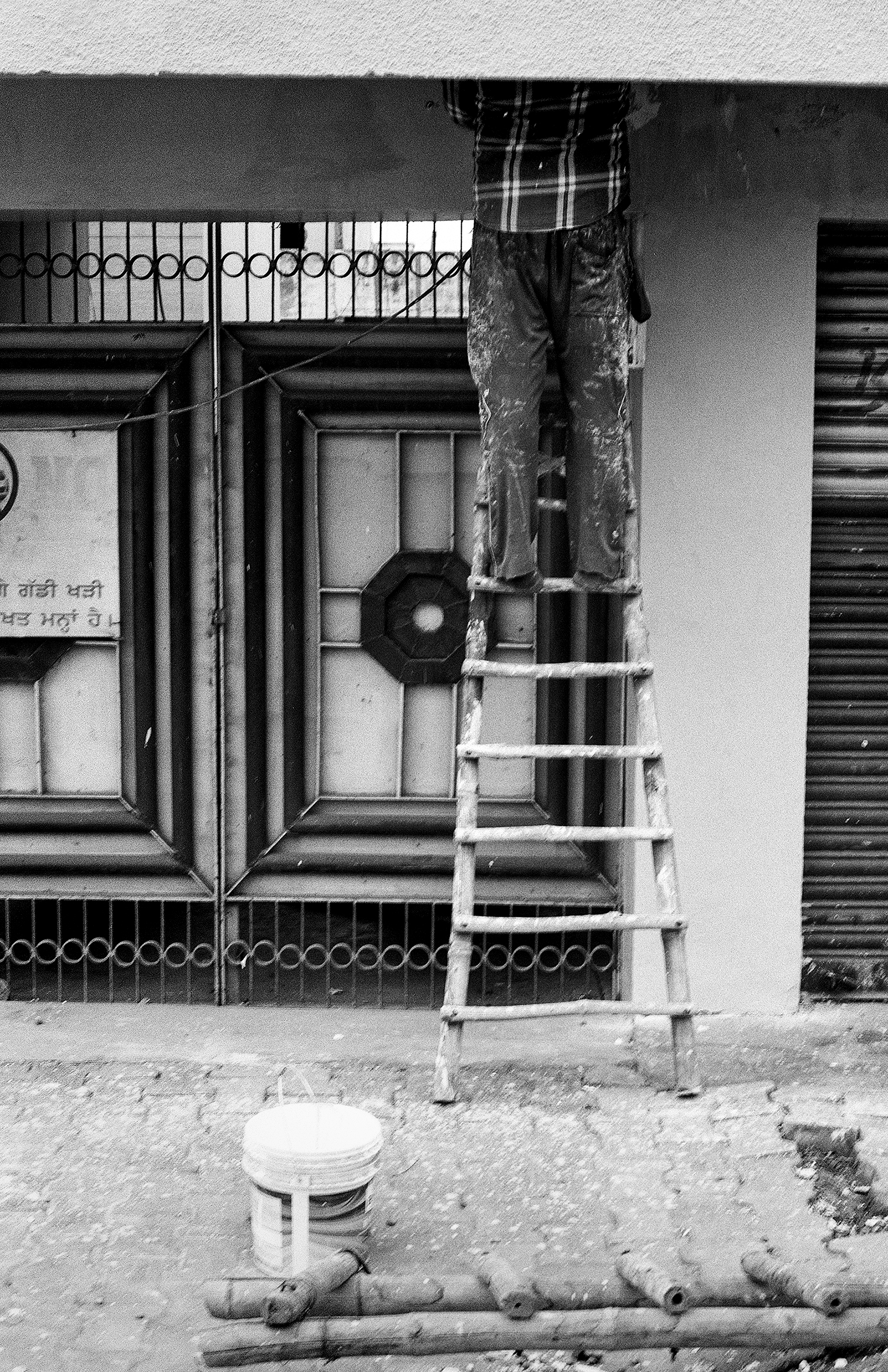 Black and white checkered cloth hanging on rope above simple weathered brick structure