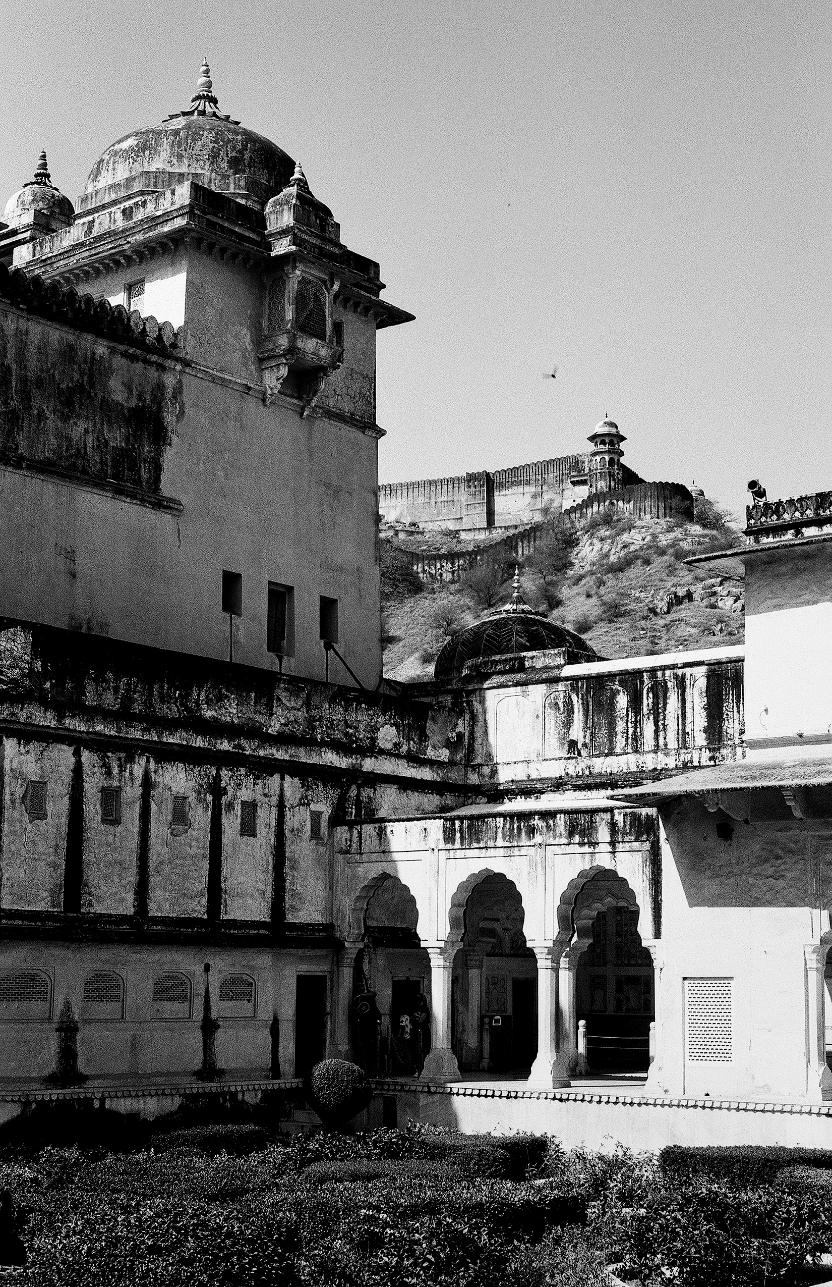 Black and white palace complex with multiple domes ornate railings arches and fortified walls