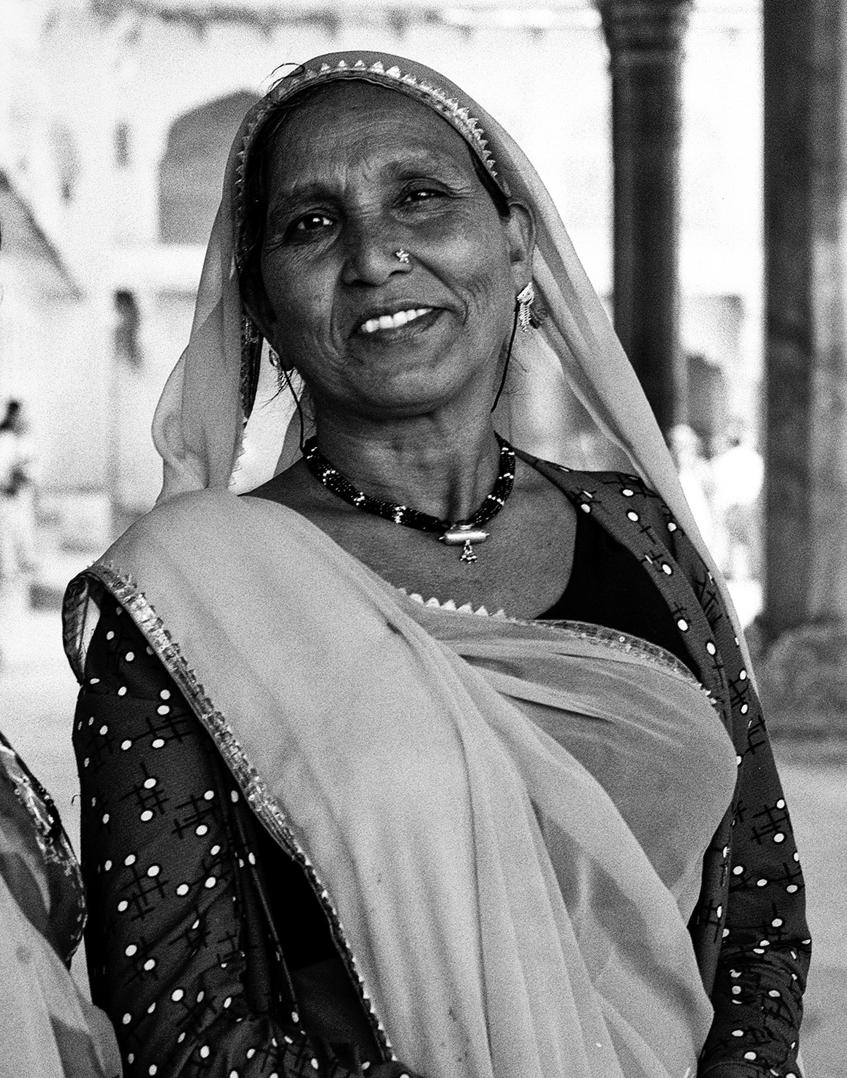 Black and white portrait of woman in traditional dress white shawl bindi and decorative jewelry