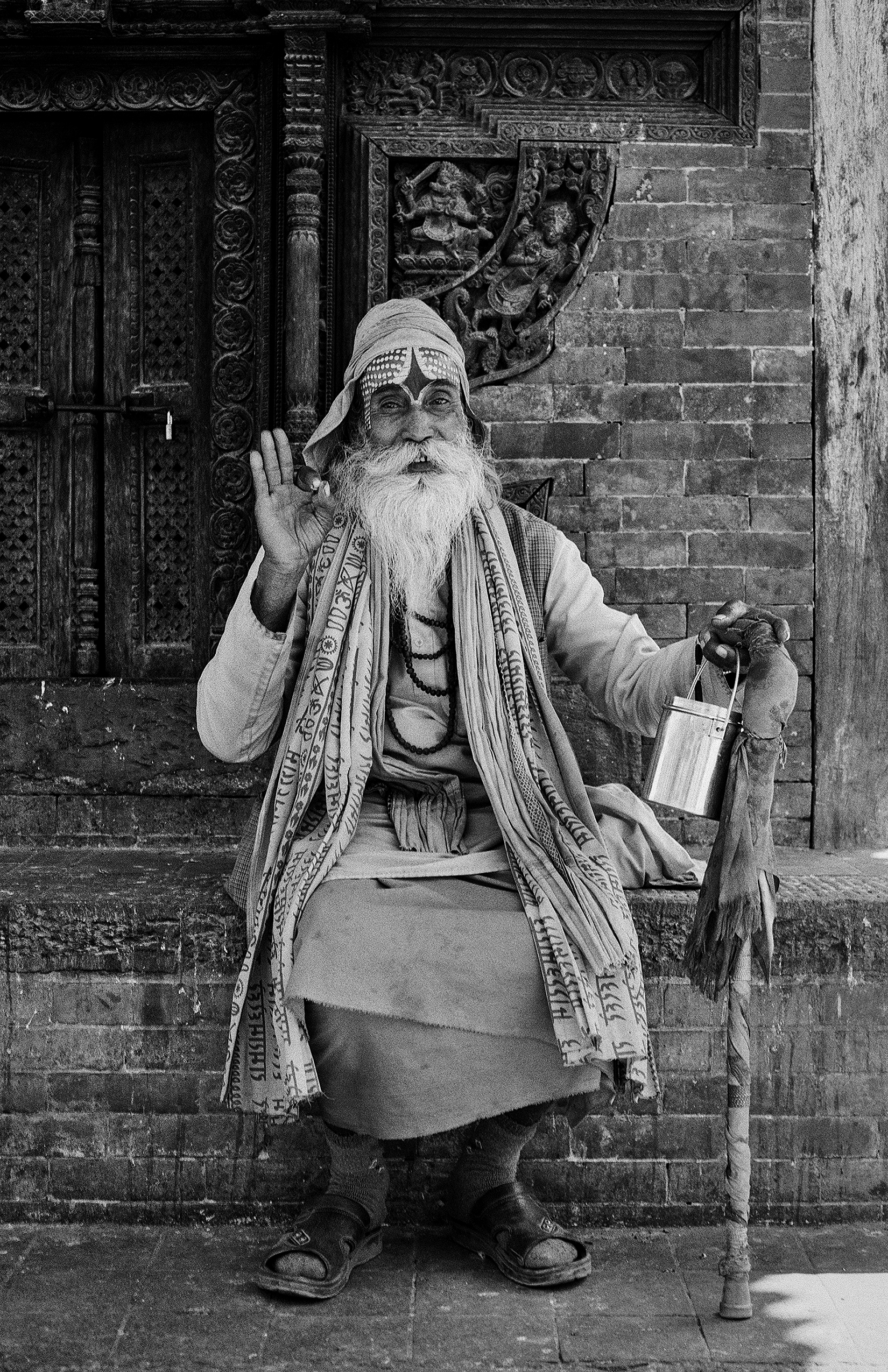 Holy man in ceremonial dress with decorated headwrap and sacred beads