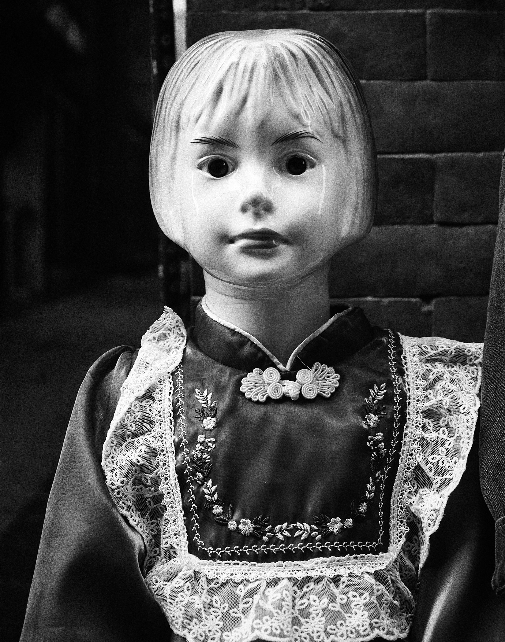 Mannequin head wearing ornate embroidered Nepali dress with decorative collar and fasteners