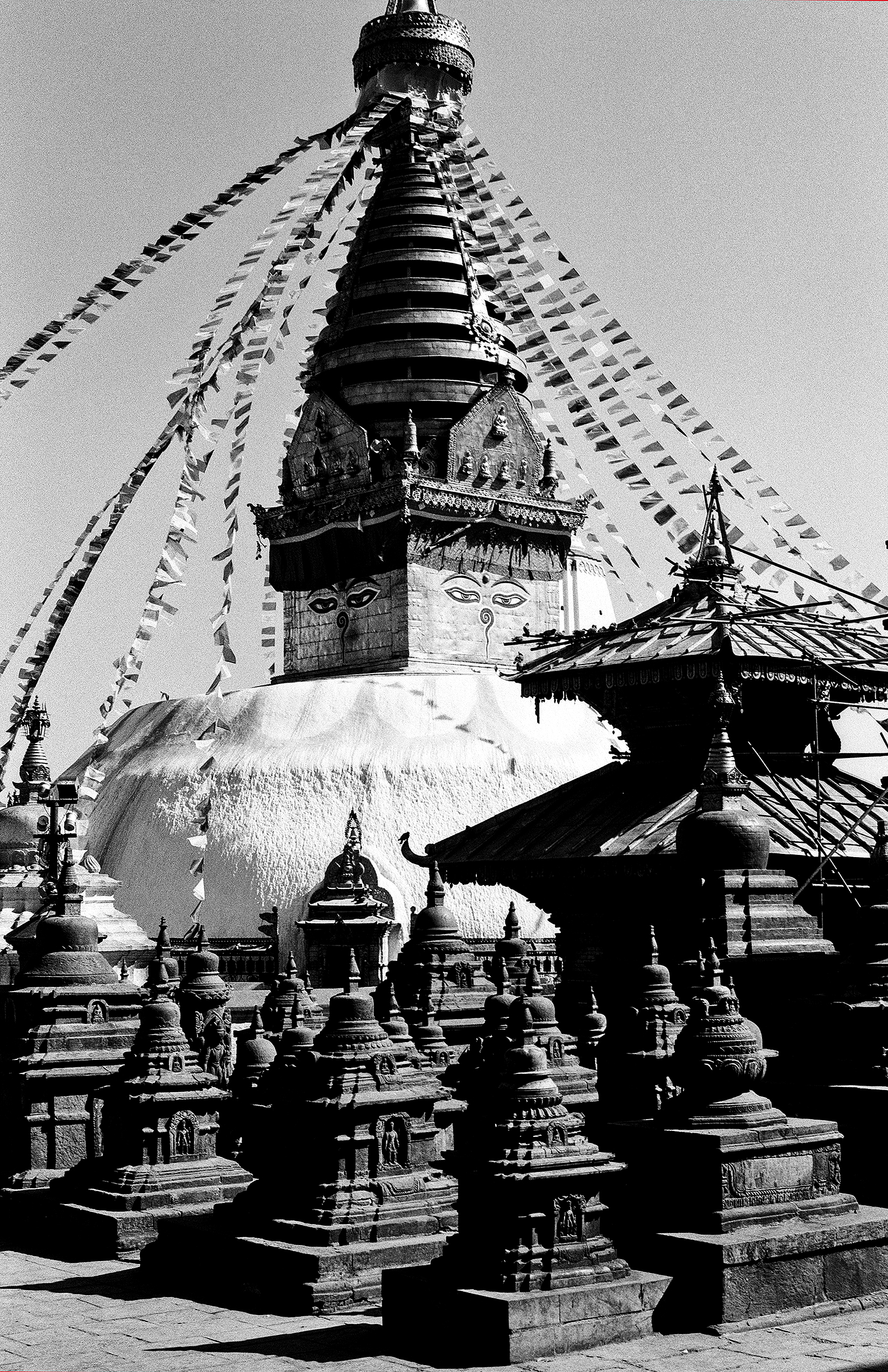 Boudhanath Stupa with iconic Buddha eyes and colorful prayer flags surrounding the dome