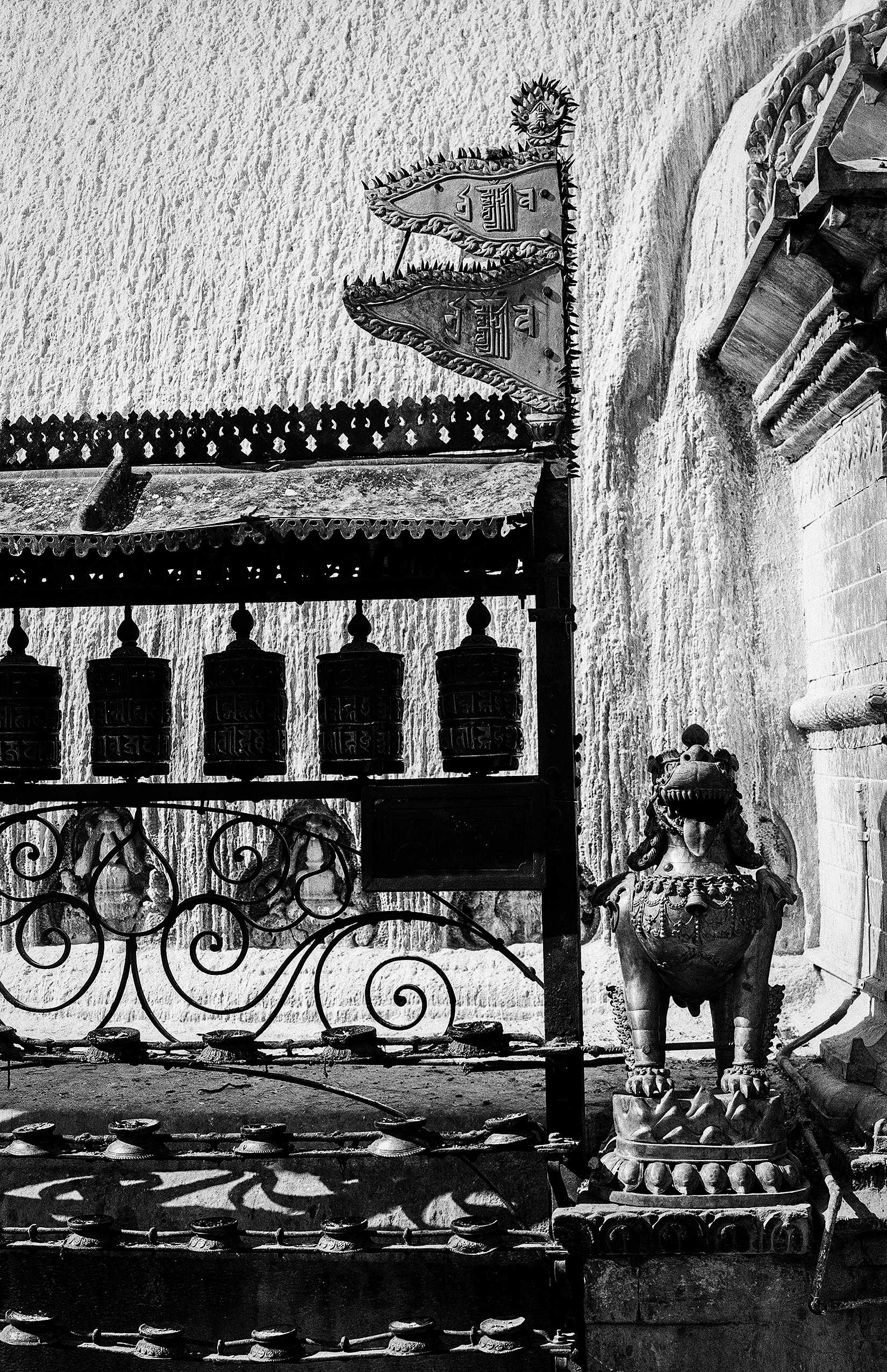 Ornamental architectural detail with dragon and serpent carvings on whitewashed temple wall