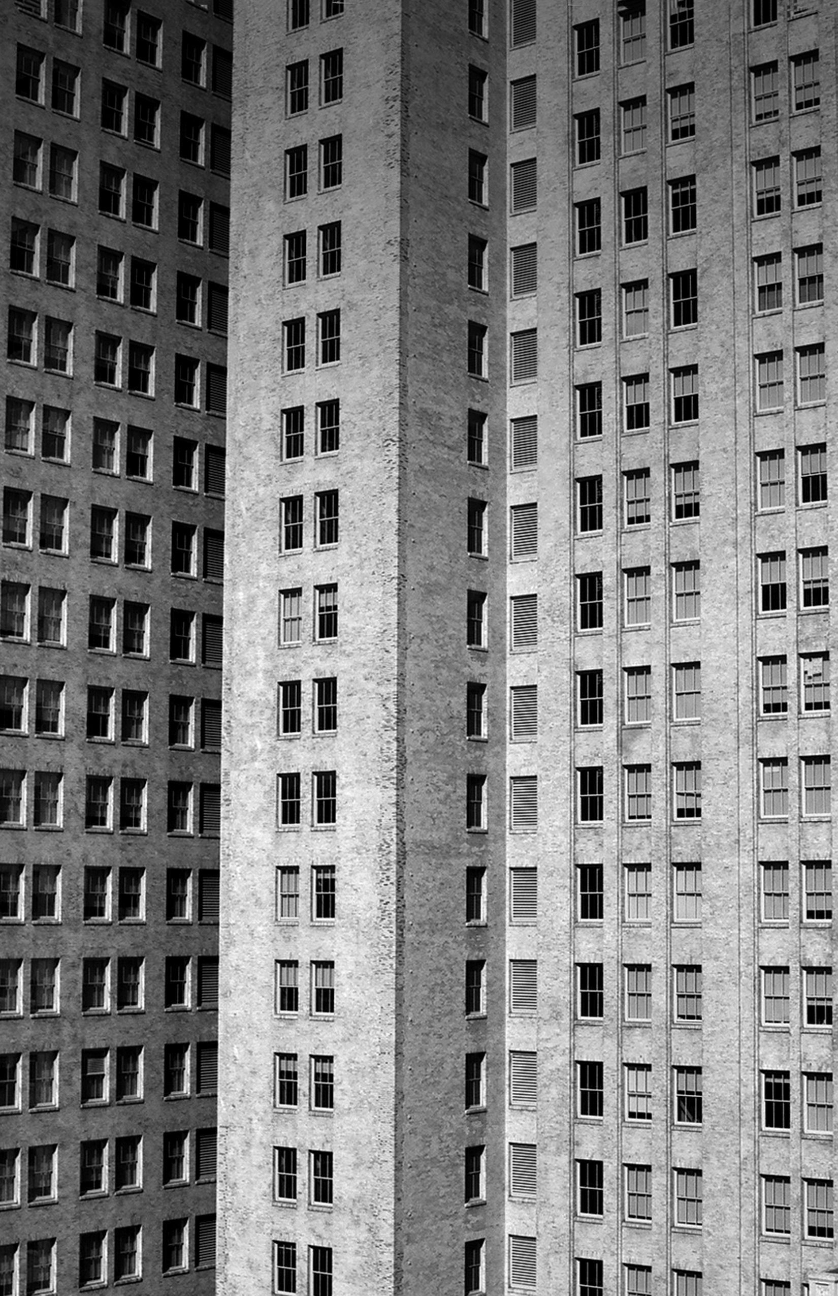 Apartment building facade showing repetitive grid of windows and geometric architectural pattern