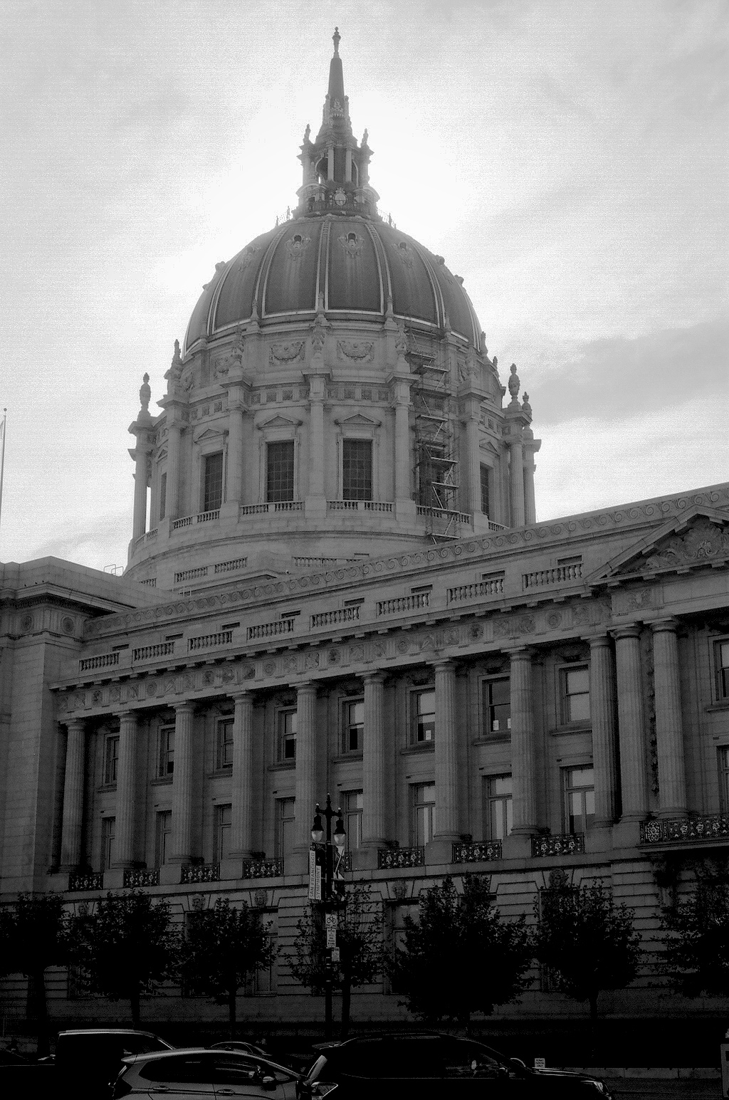 City Hall Beaux-Arts domed civic building with iconic copper dome and neoclassical columns photographed from ground level with parked cars
