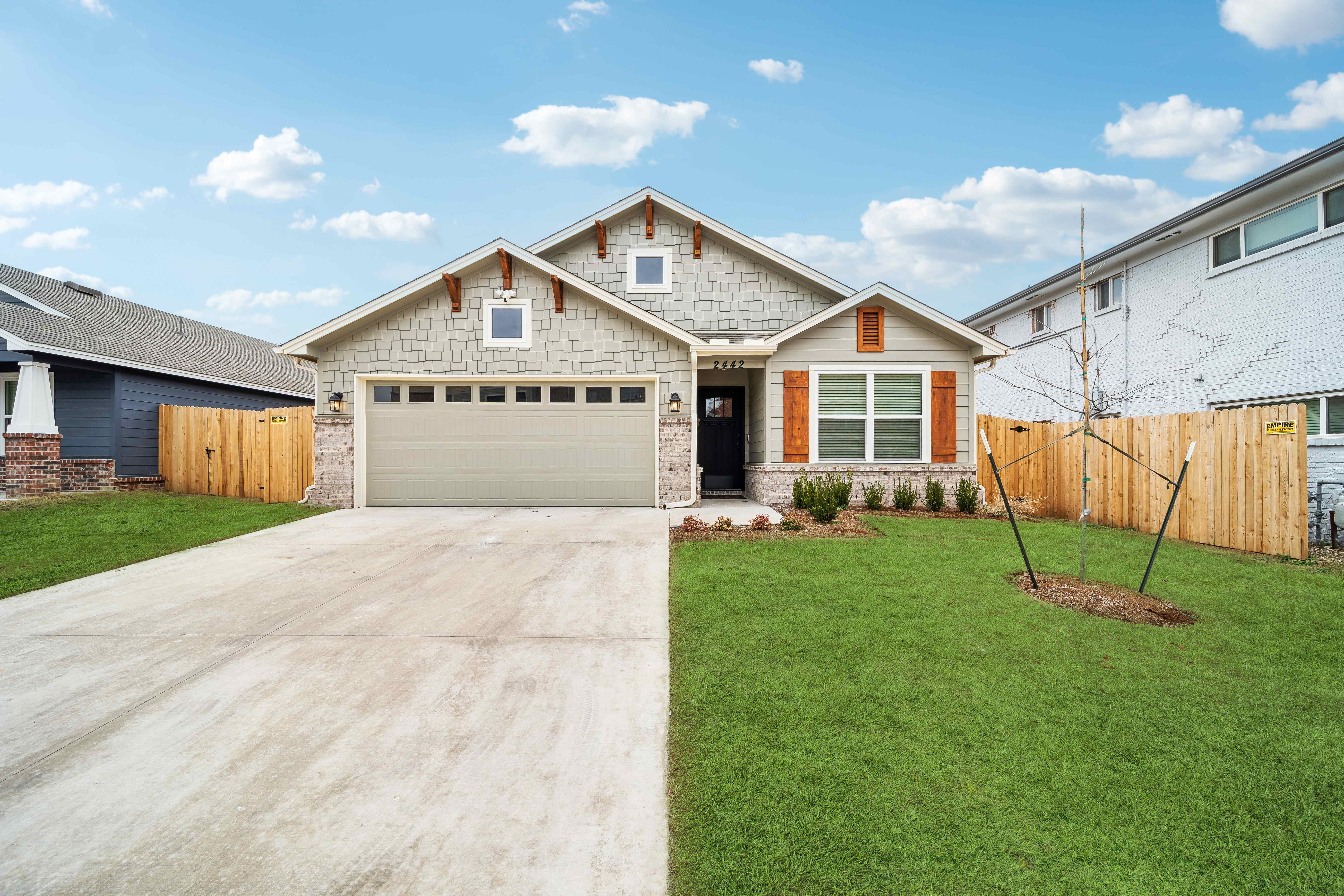 House exterior - craftsman style home with garage and green lawn