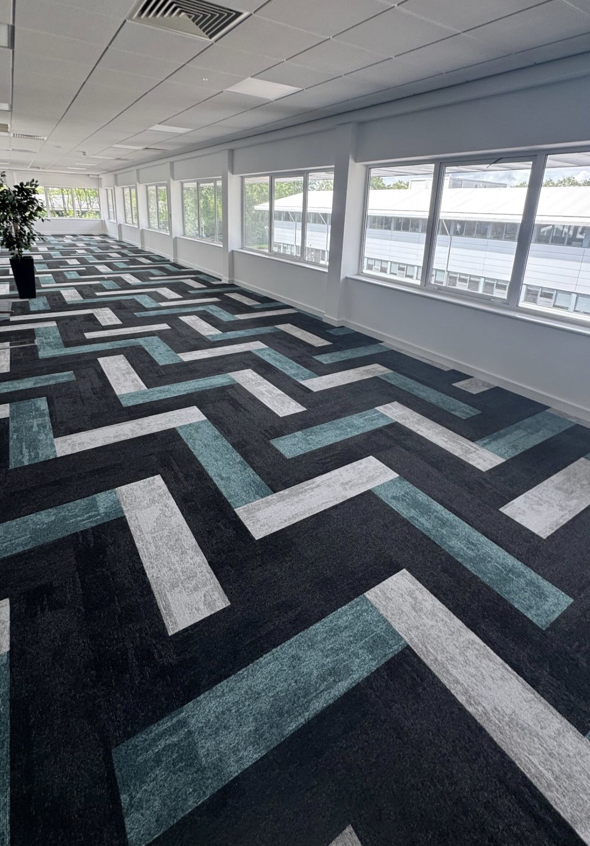 Large office space with bespoke geometric carpet design