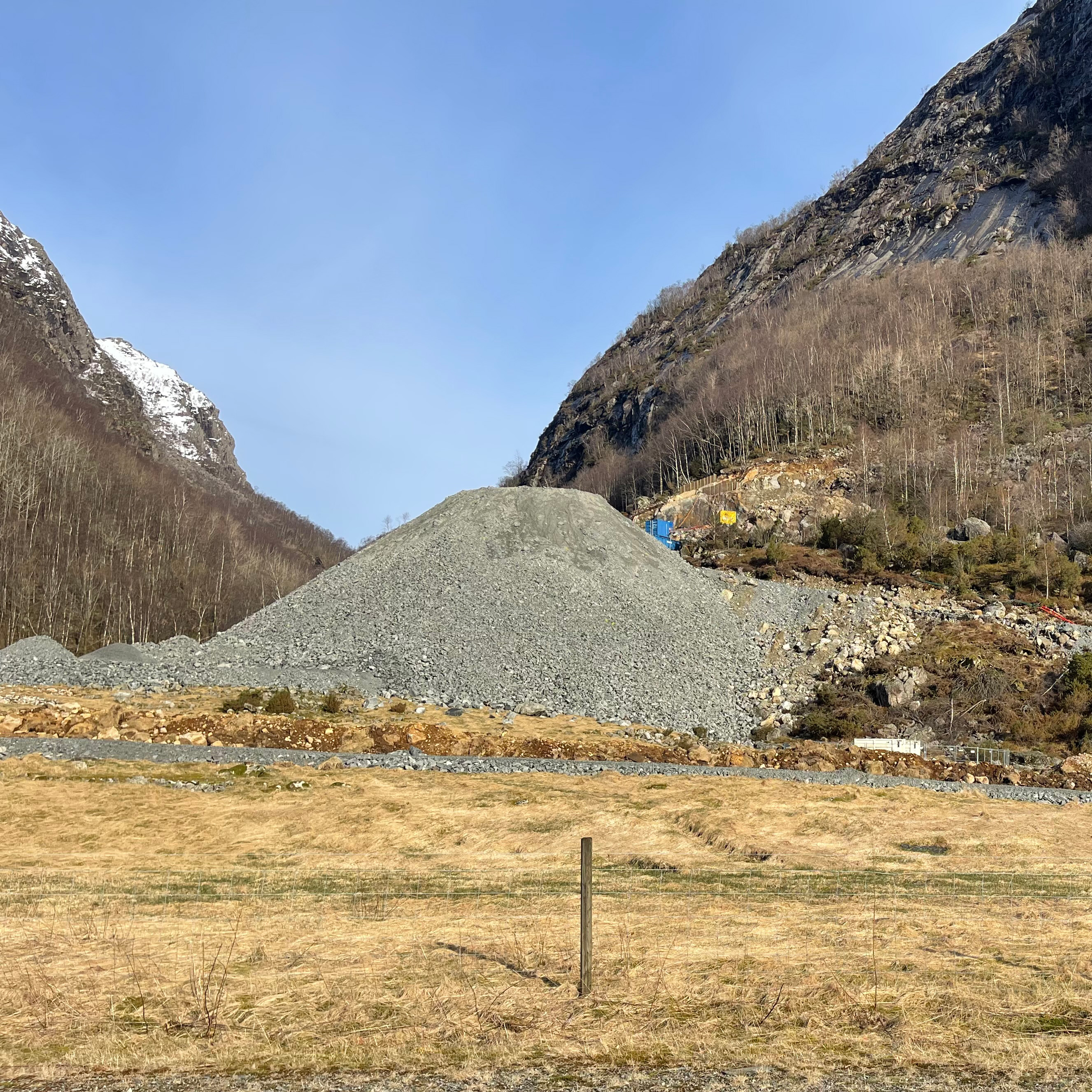 Large spoil deposit pile from traditional blasting