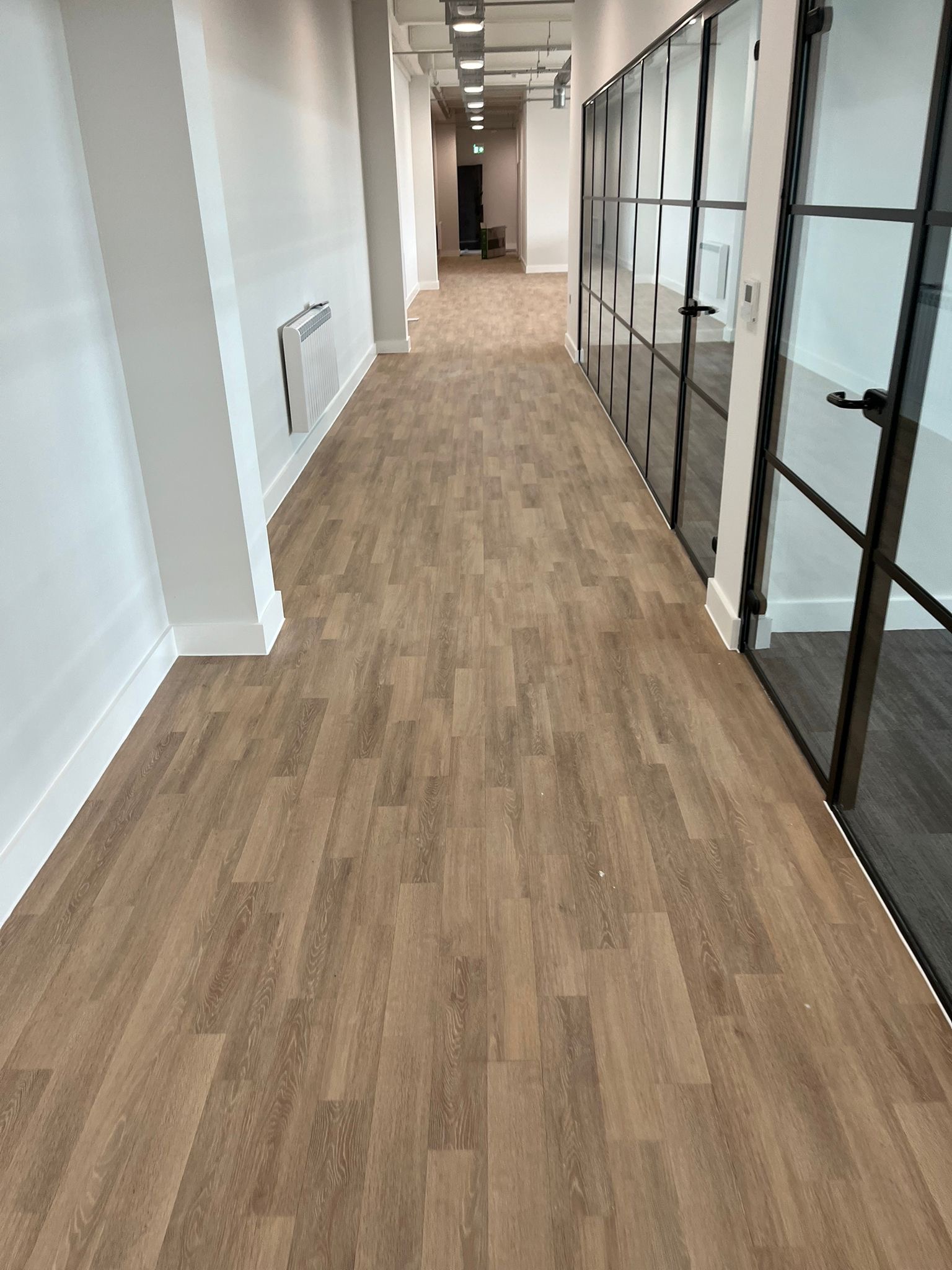 Office corridor with light oak vinyl plank flooring