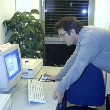 Junger Mann arbeitet allein am CRT-Computer