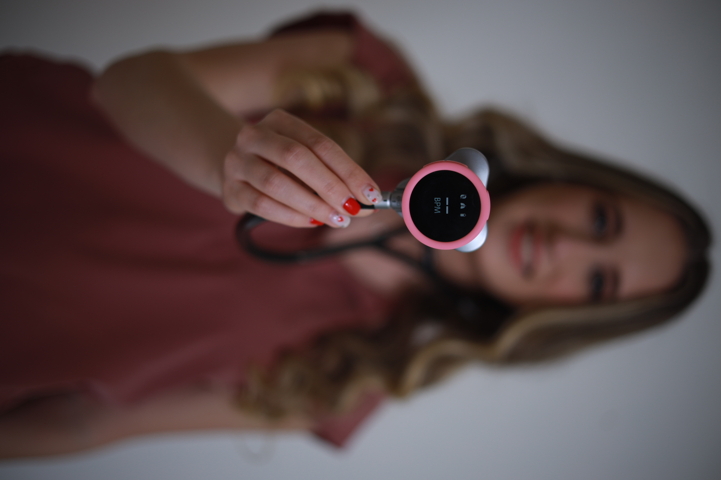 Close-up of a digital stethoscope with a BPM display held in hand