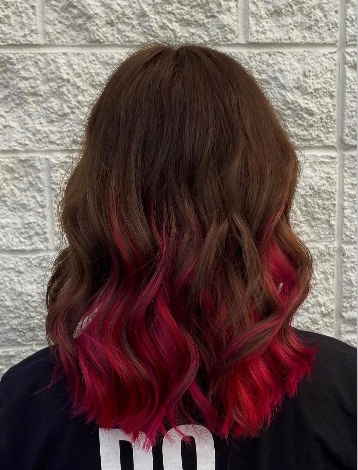 Brown hair with vibrant pink color melt