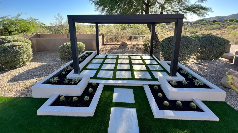 Modern turf and paver checkerboard patio under a black pergola