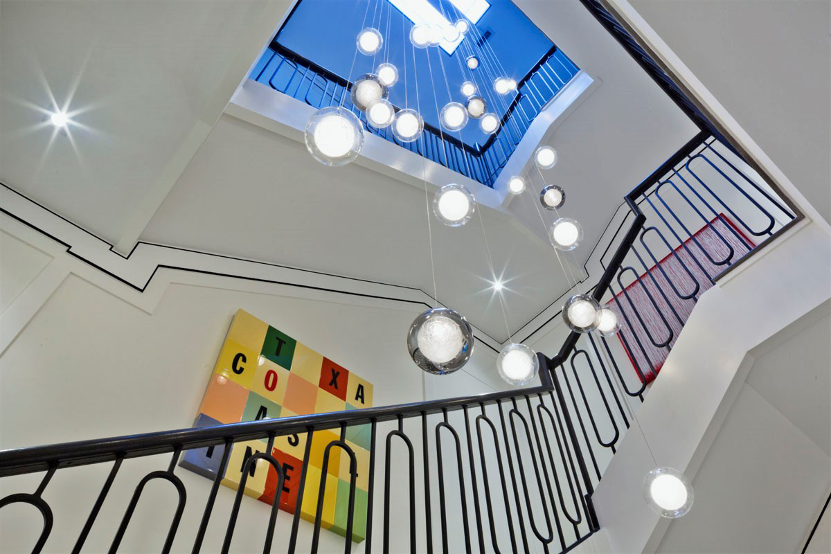 Architectural staircase with skylight and bubble chandelier
