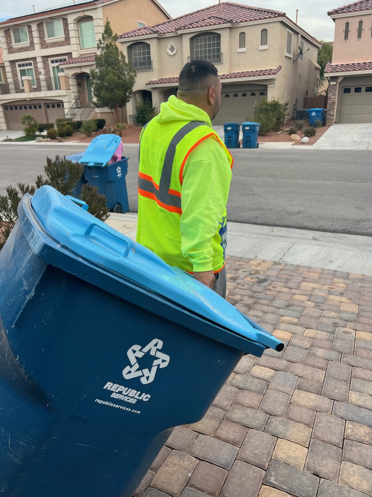Win City Bins team member moving a residential recycling bin in a Las Vegas neighborhood