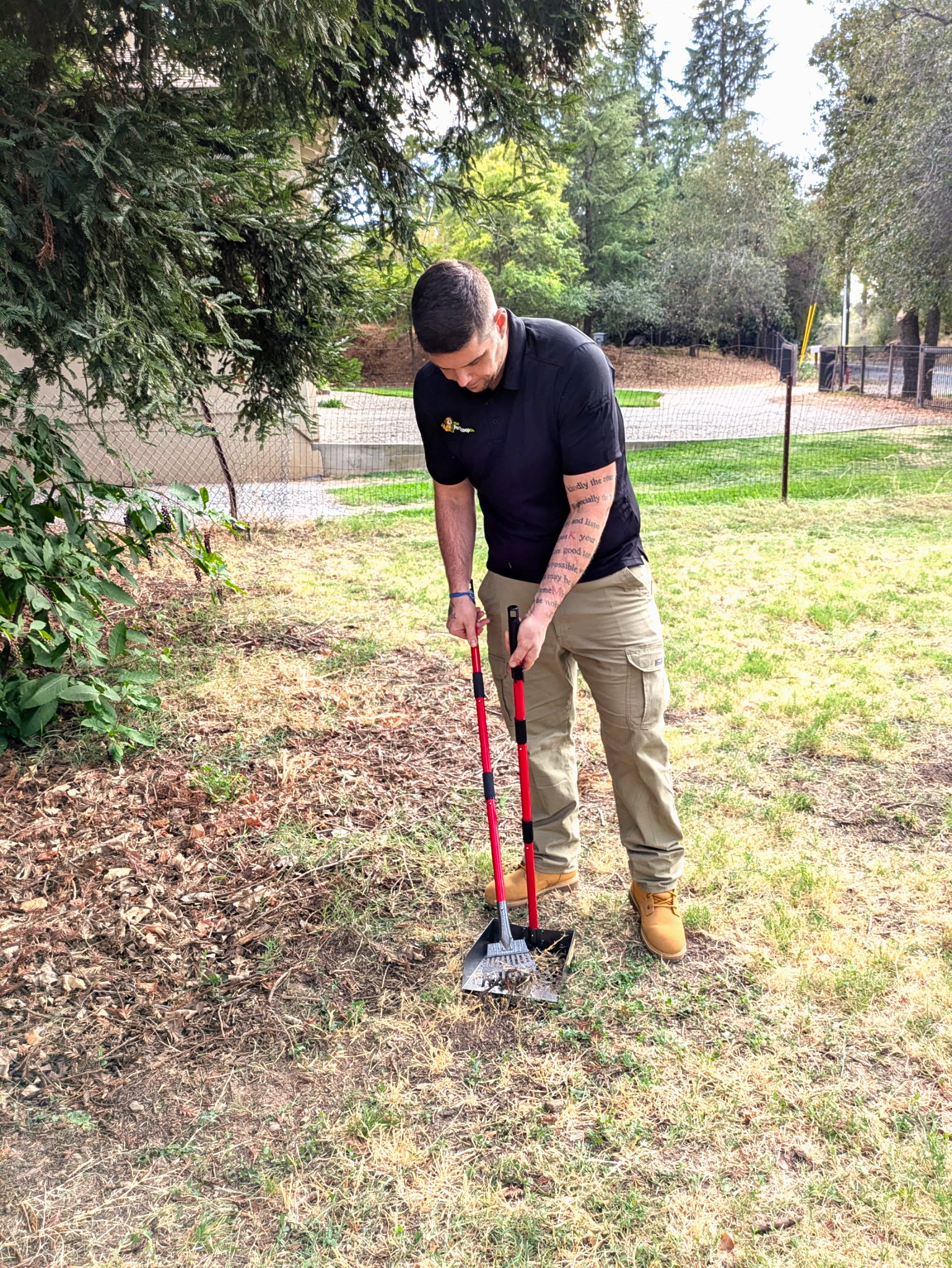 Poop Scoop Co. team member scooping a residential yard