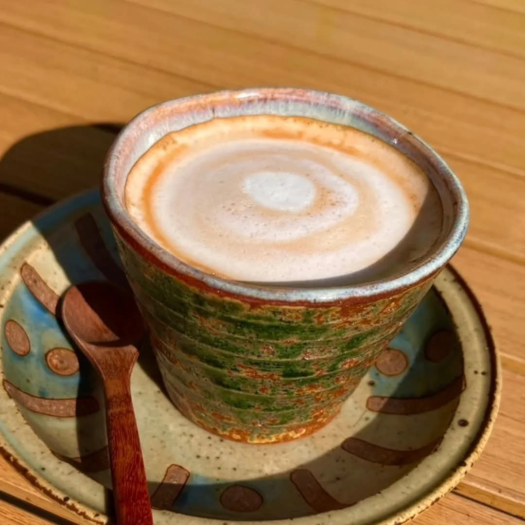 Artisanal latte in handcrafted ceramic cup with detailed latte art