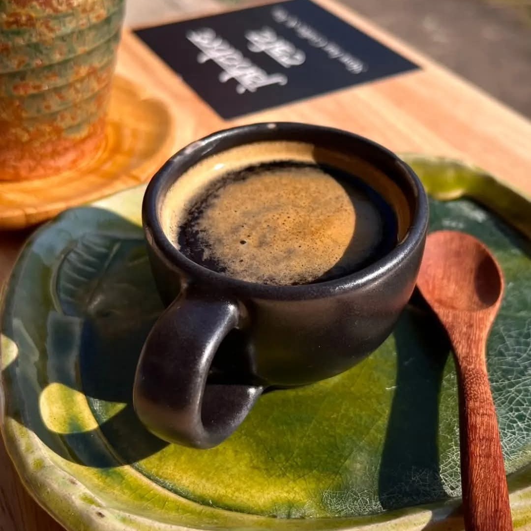 Traditional Thai coffee served in black ceramic cup