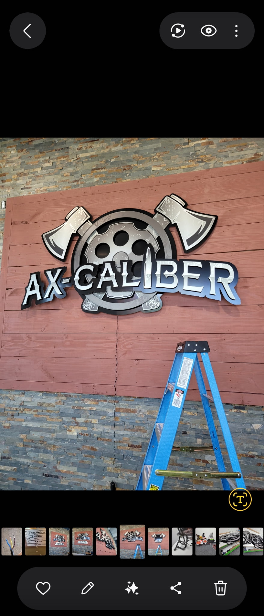AX-CALIBER large dimensional chrome logo sign with custom axe artwork on reclaimed wood wall
