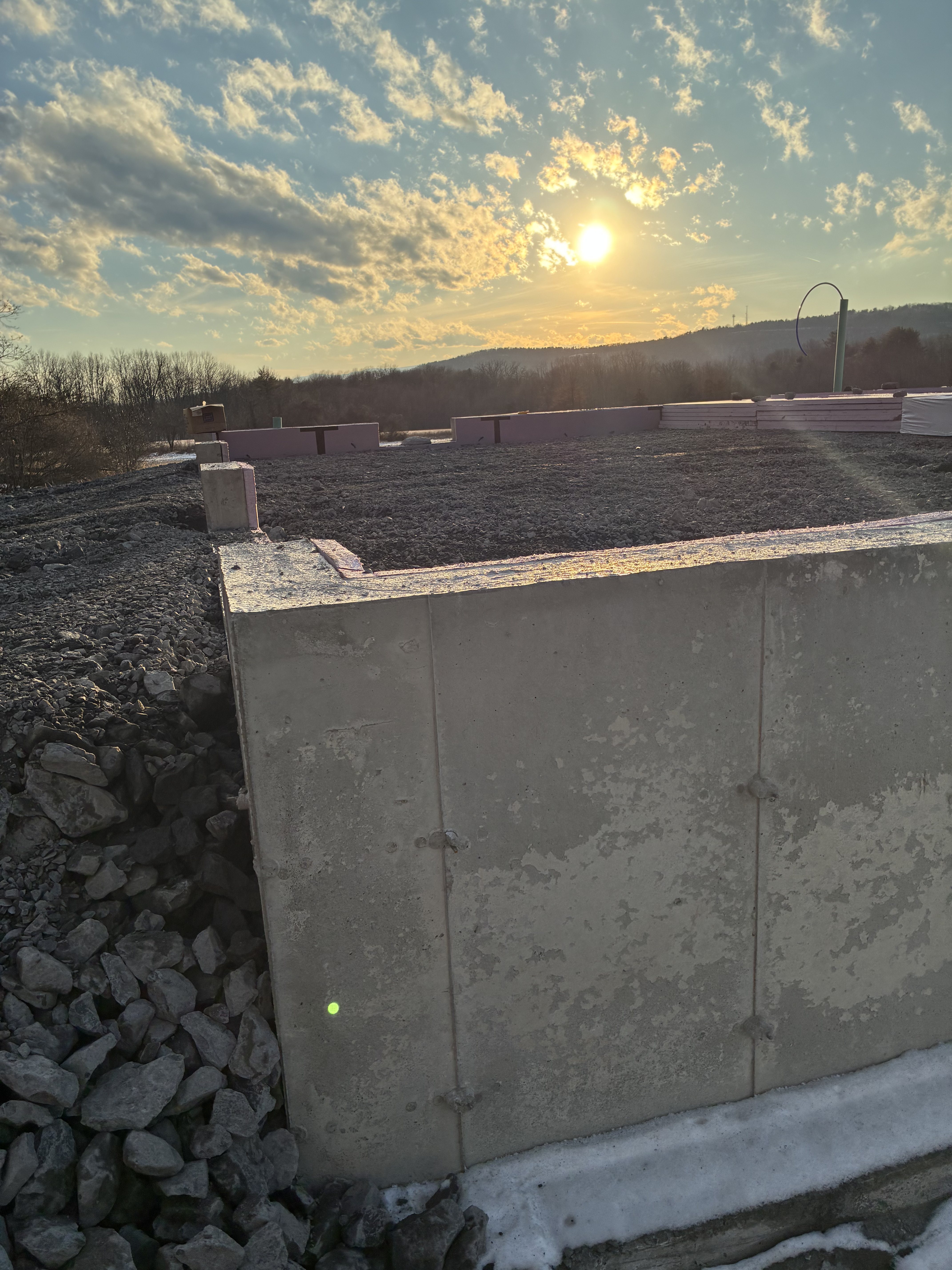 Poured concrete foundation wall at sunset