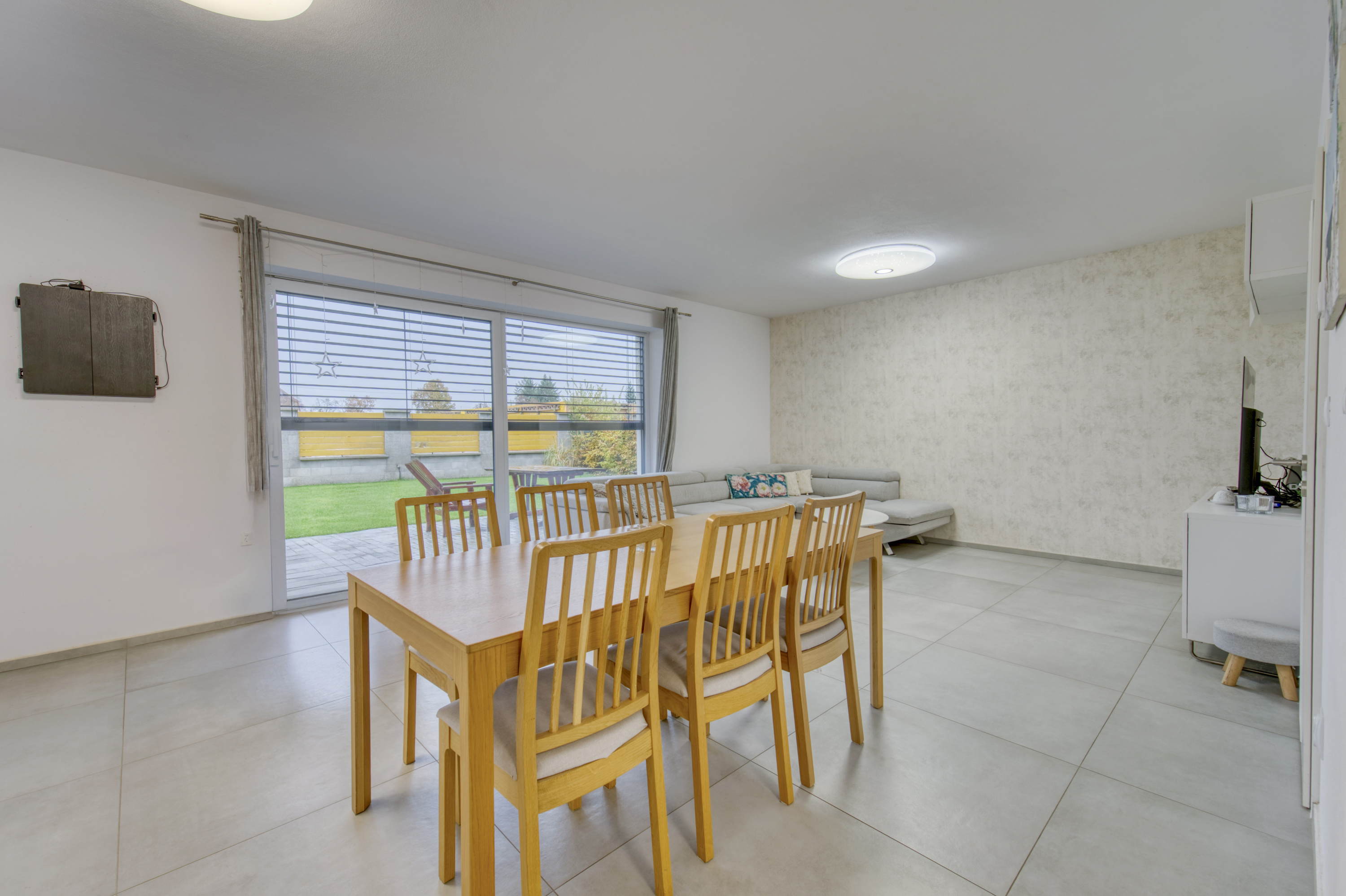 Open dining room with wood table and garden view
