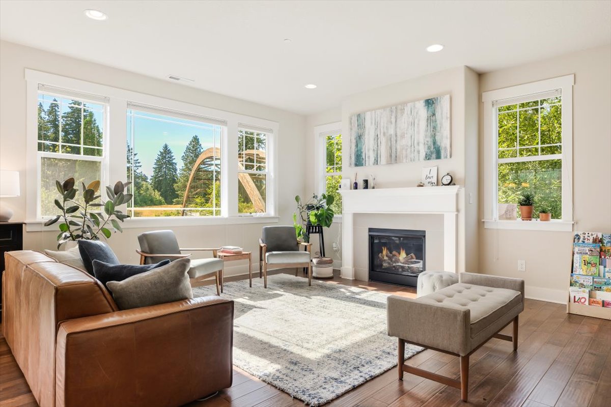 Bright modern living room with multiple windows, natural light, and professional staging
