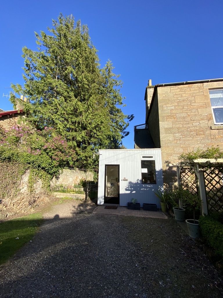 Charming Scottish cottage with mature trees and tidy gravel driveway